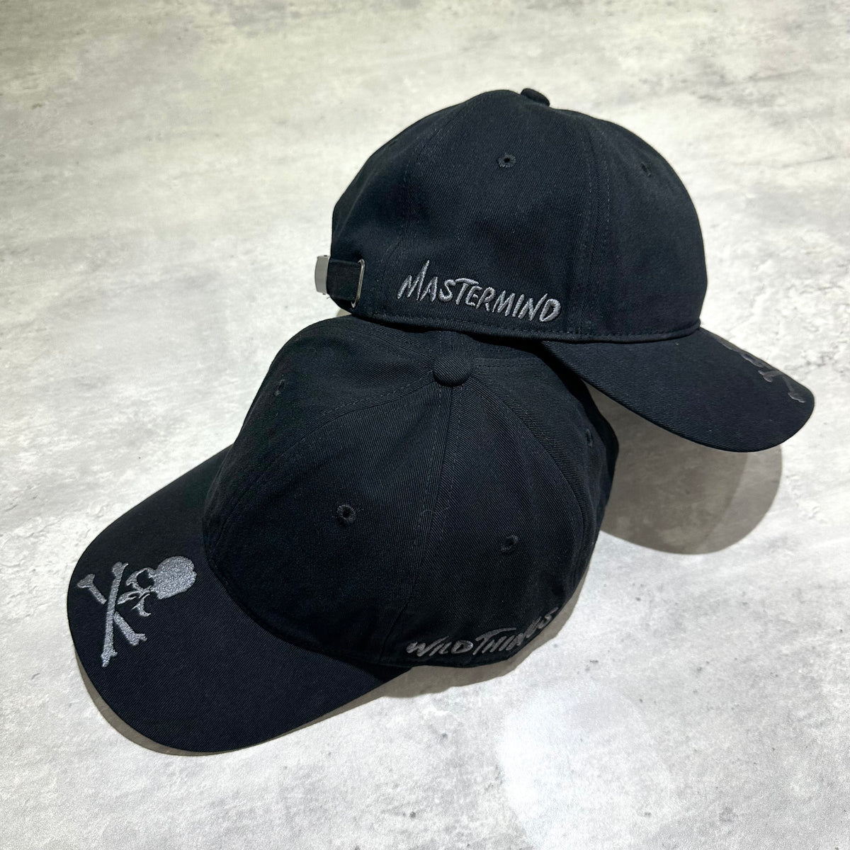 Wild Things x Mastermind World Tee Cap featuring a double black design with logo embroidery on the front.