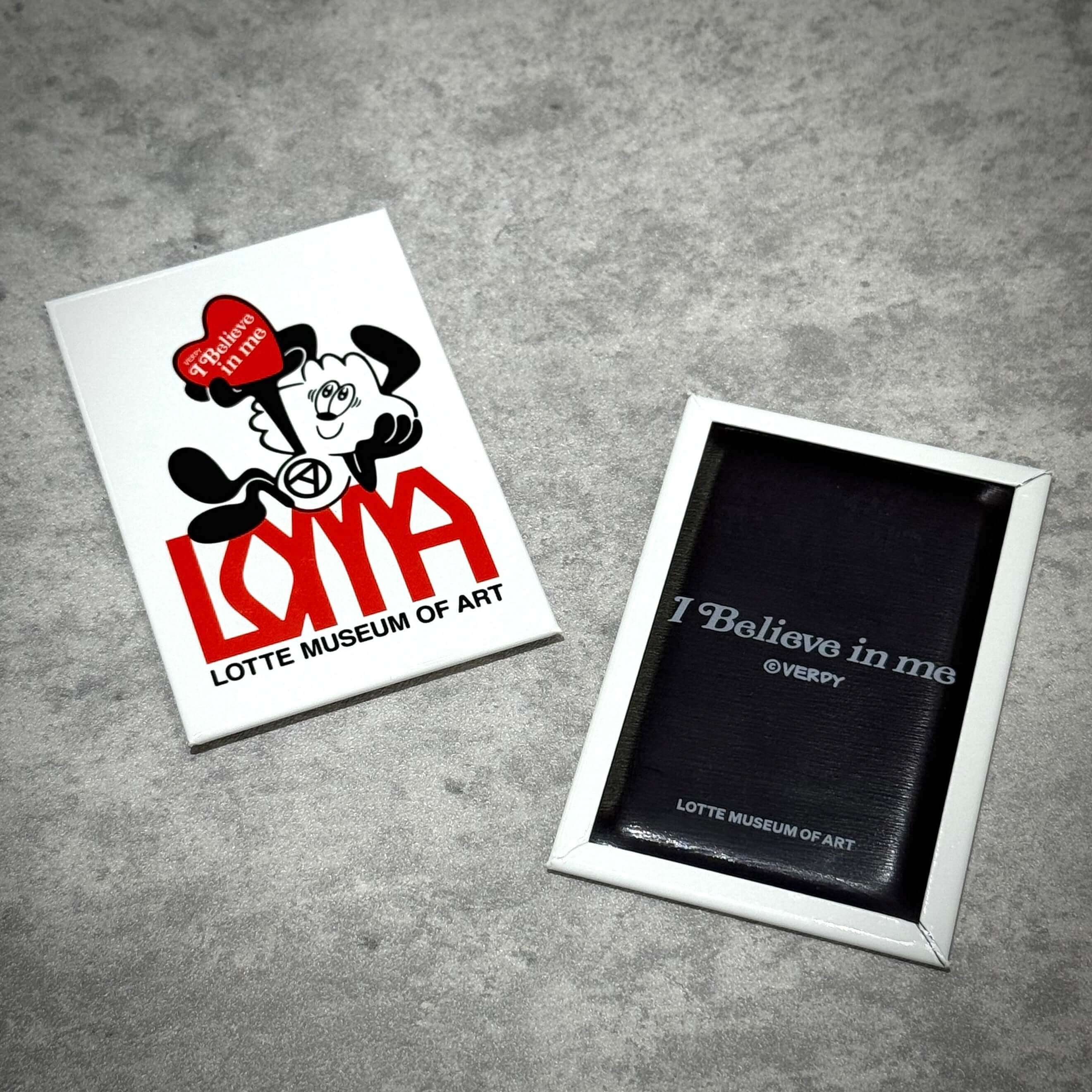 Verdy x Lottemuseum accessories featuring a love-themed artwork and quote in a frame.