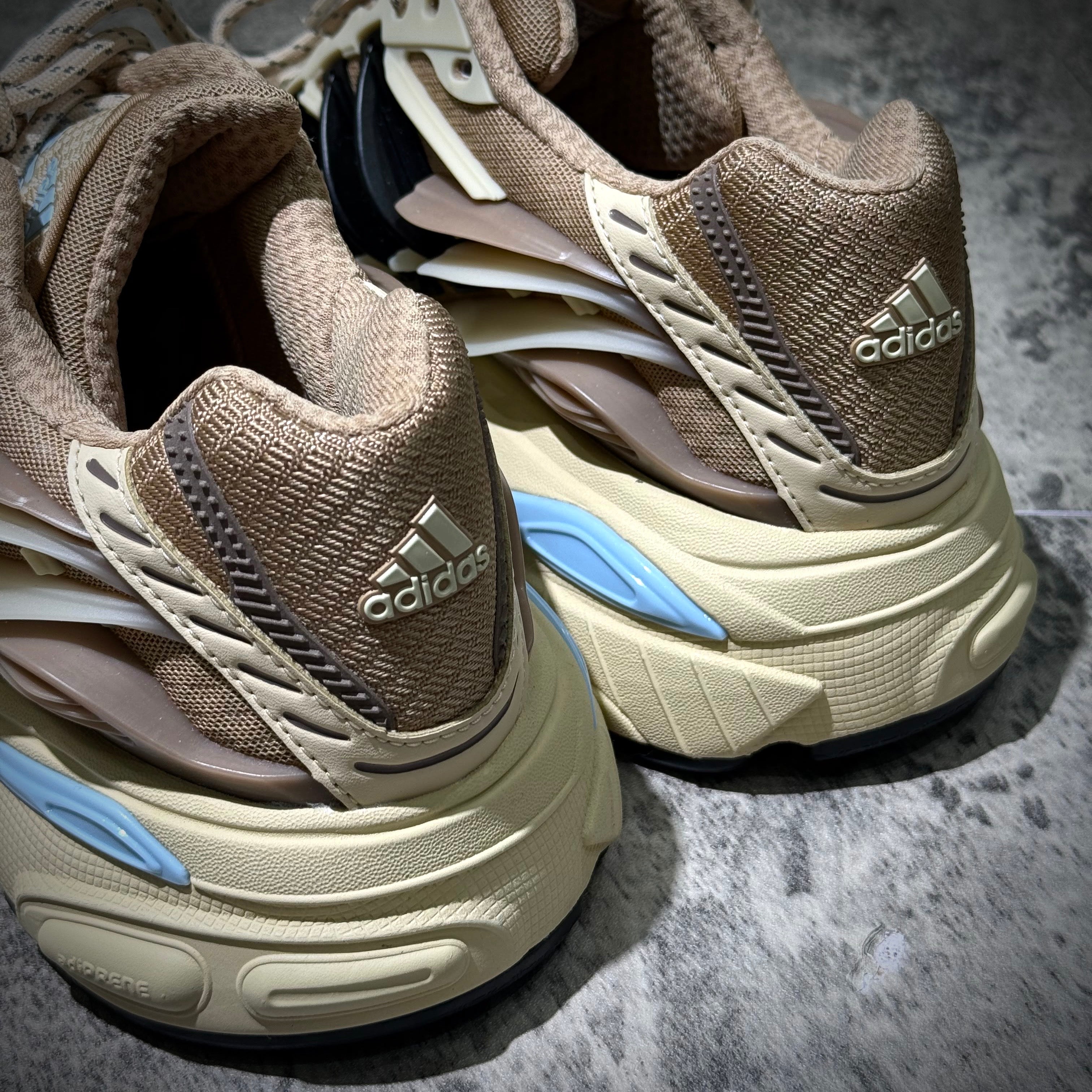 Close-up of adidas Adistar Jellyfish by Pharrell Williams Crystal Sand KH6729 sneakers, showcasing detailed design and branding.
