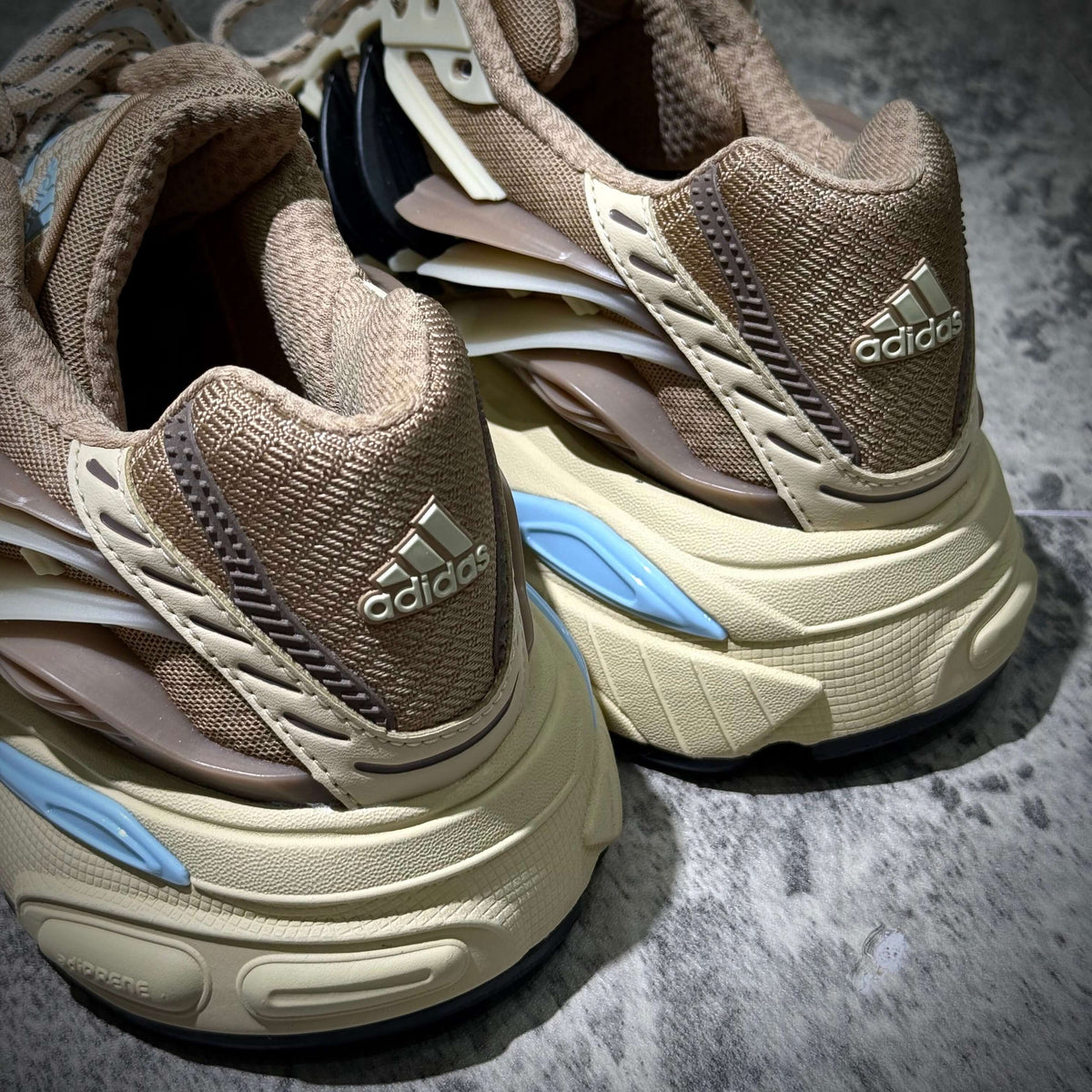 Close-up of adidas Adistar Jellyfish by Pharrell Williams Crystal Sand KH6729 sneakers, showcasing detailed design and branding.