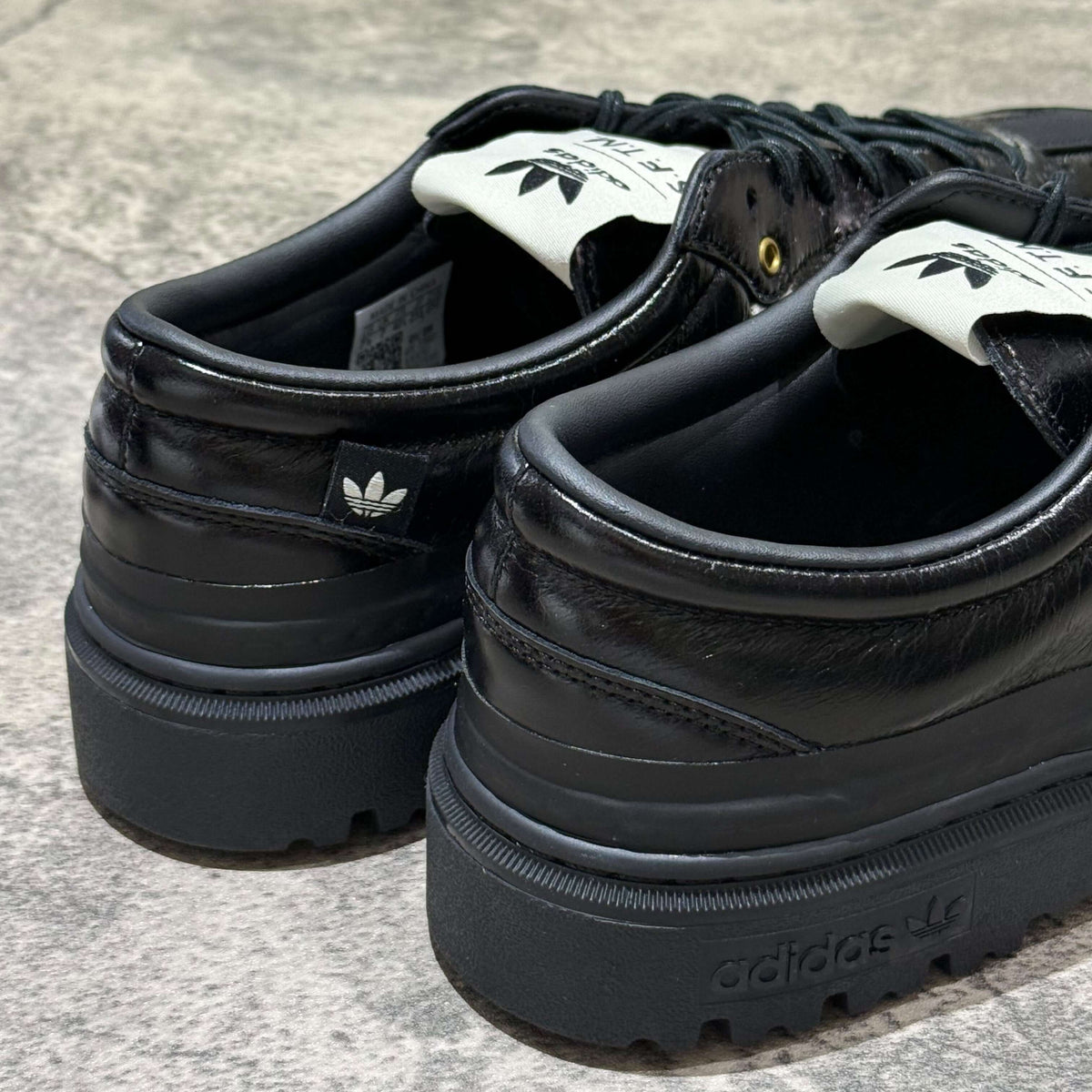 adidas Samba LX Freizeit x Song For The Mute black sneaker close-up showing heel and branding details.