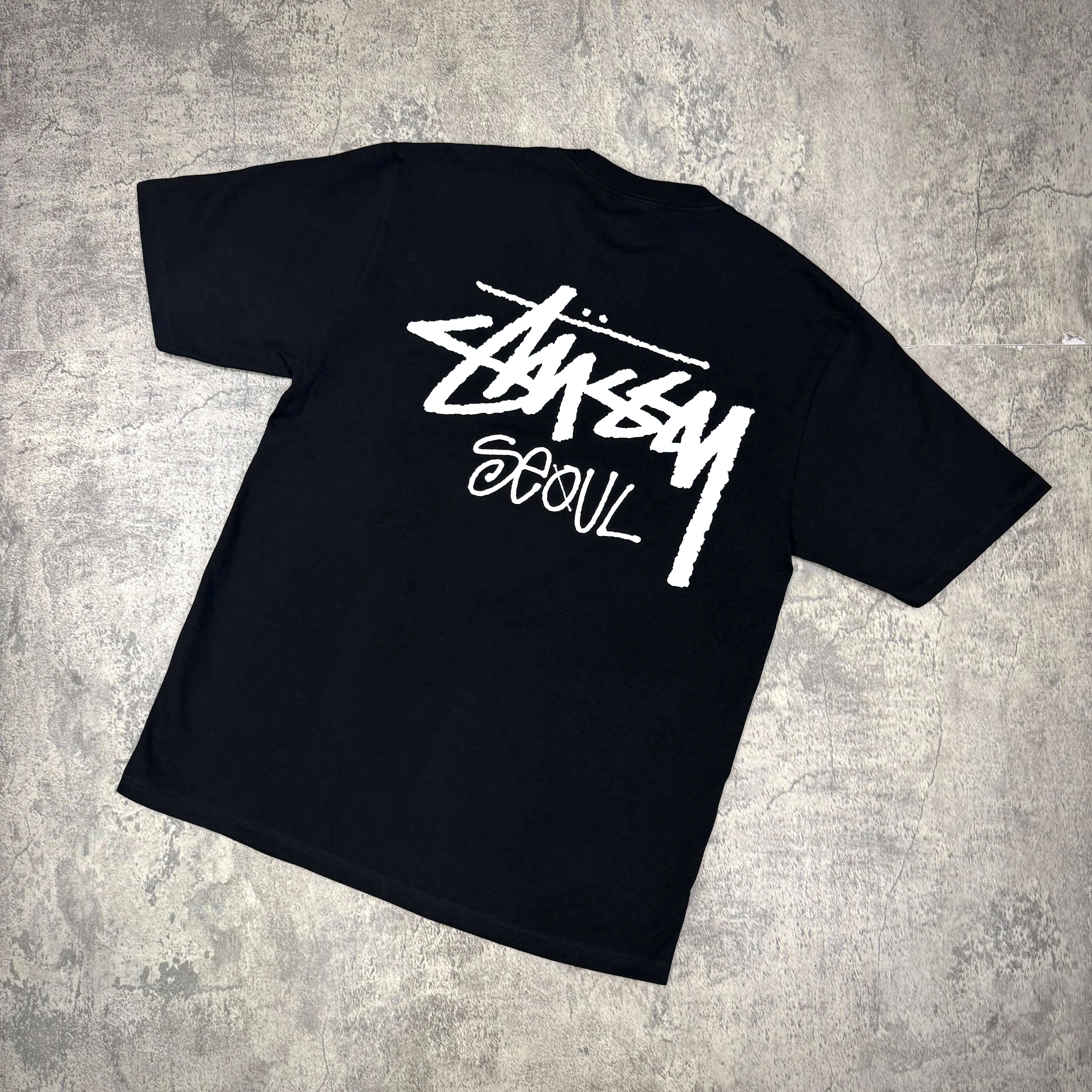 Stussy Seoul Exclusive Logo Tee in black featuring a bold Stussy Seoul logo on the back.