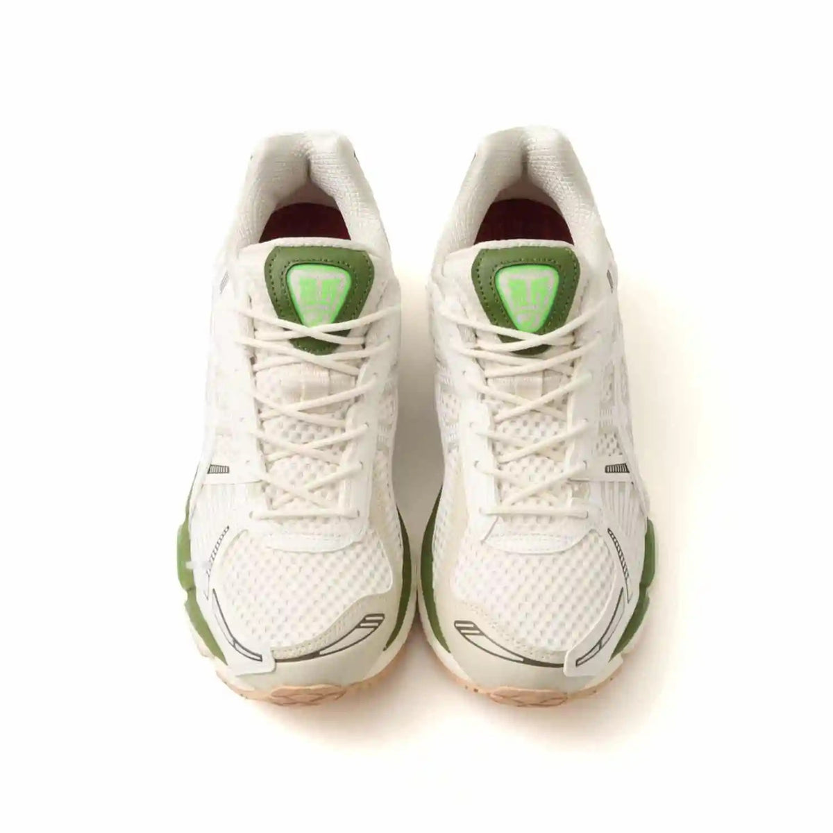 Top view of atmos x Asics Gel-Kayano 12.1 Archipelago sneakers with white mesh and green accents.