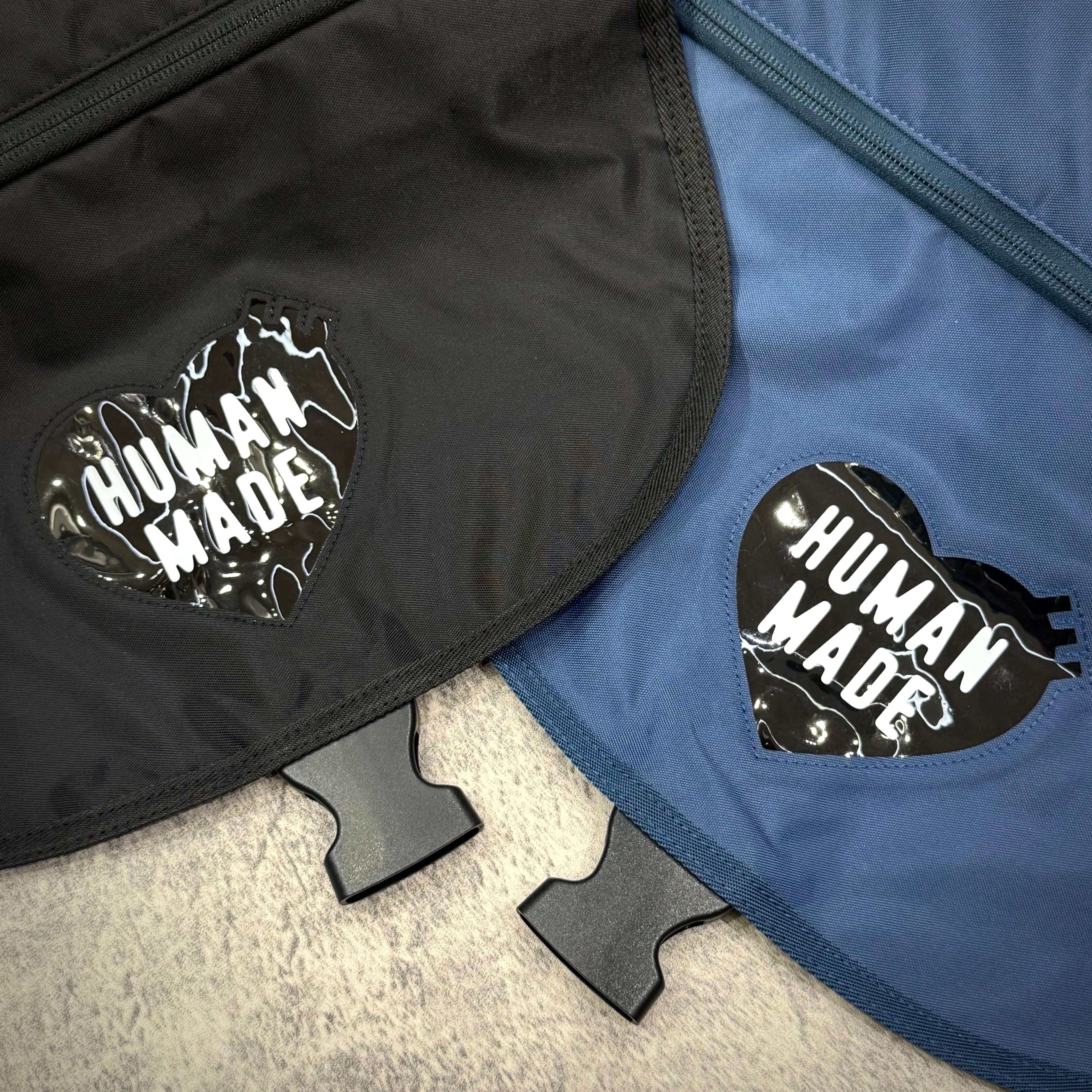 Human Made Nylon Shoulder Bag featuring black and blue color options with heart-shaped logo.