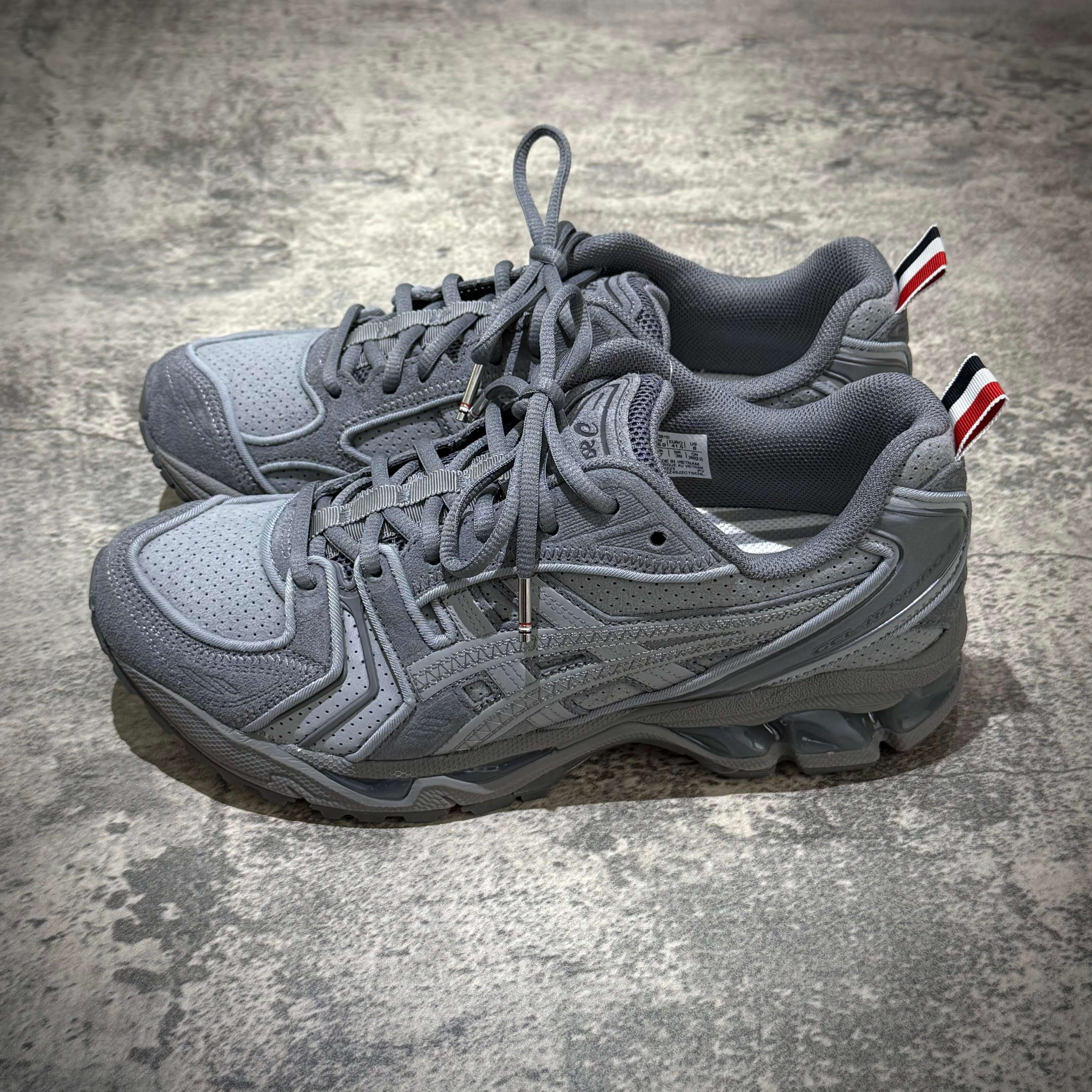 Thom Browne x Asics Gel-Kayano 14 in Grey with signature details and stylish design.
