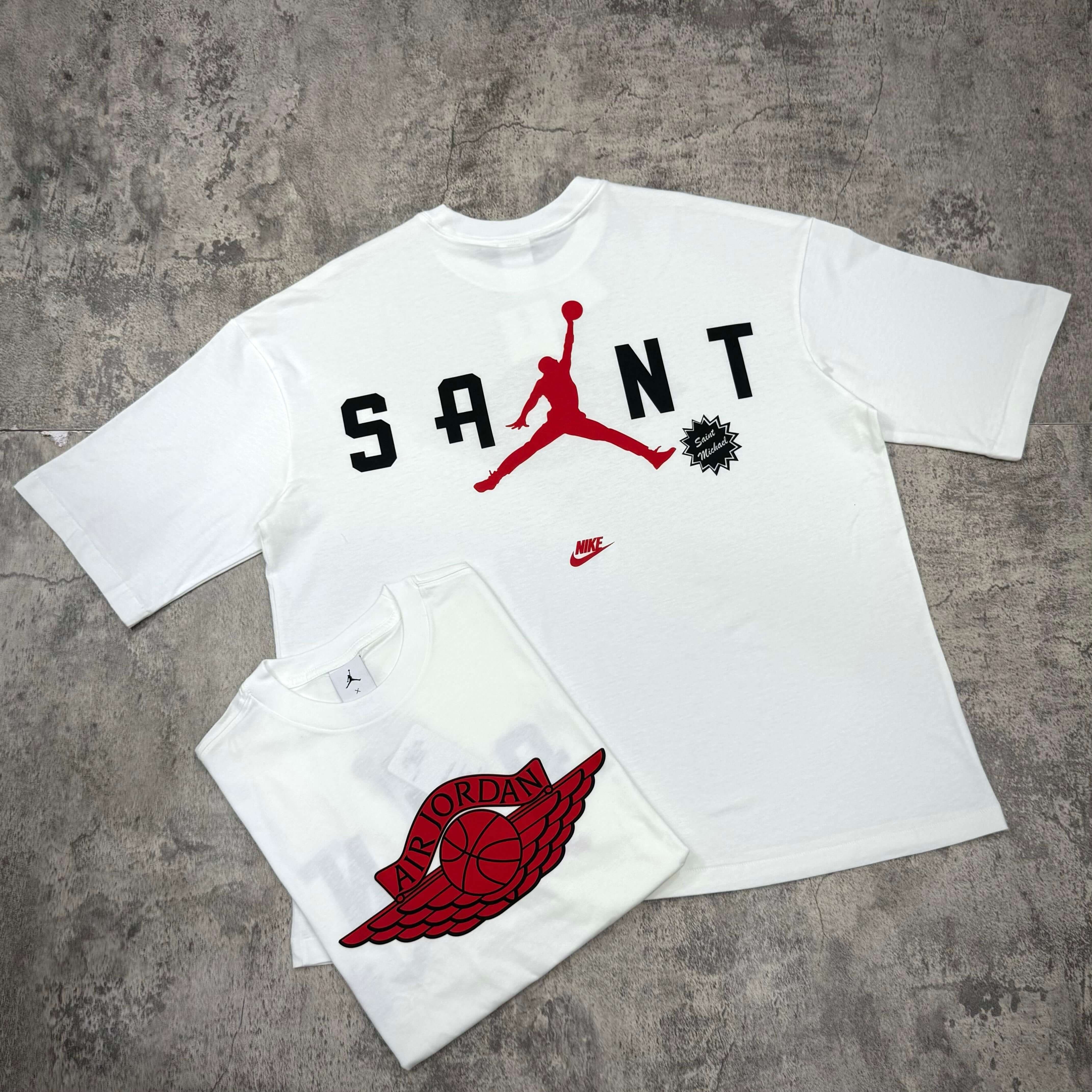 Saint Mxxxxxx Michael Jordan TIME CAPSULE Tee displayed with iconic Winged Logo design in white and red color scheme.