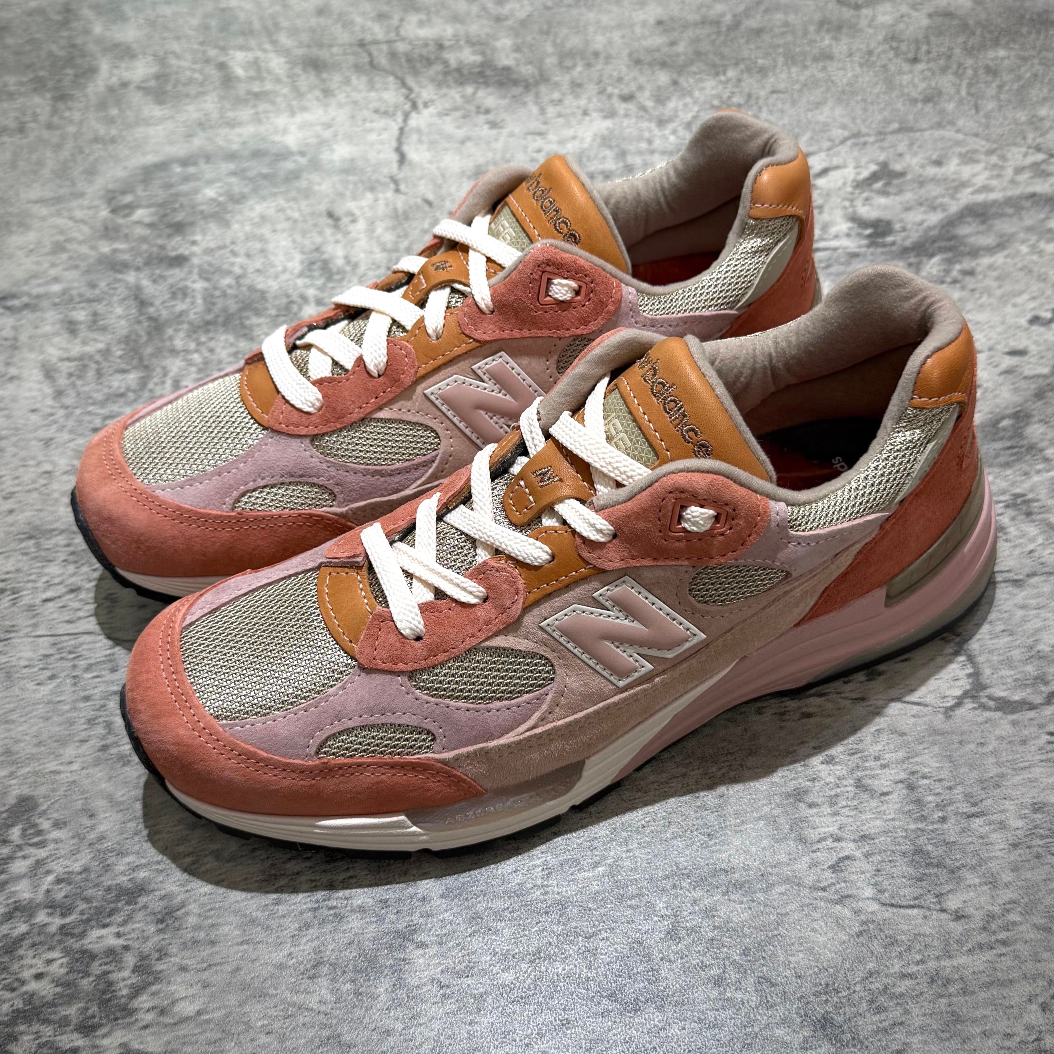 Joe Freshgoods x New Balance Made in USA 992 sneakers in pink and orange tones on a textured surface.