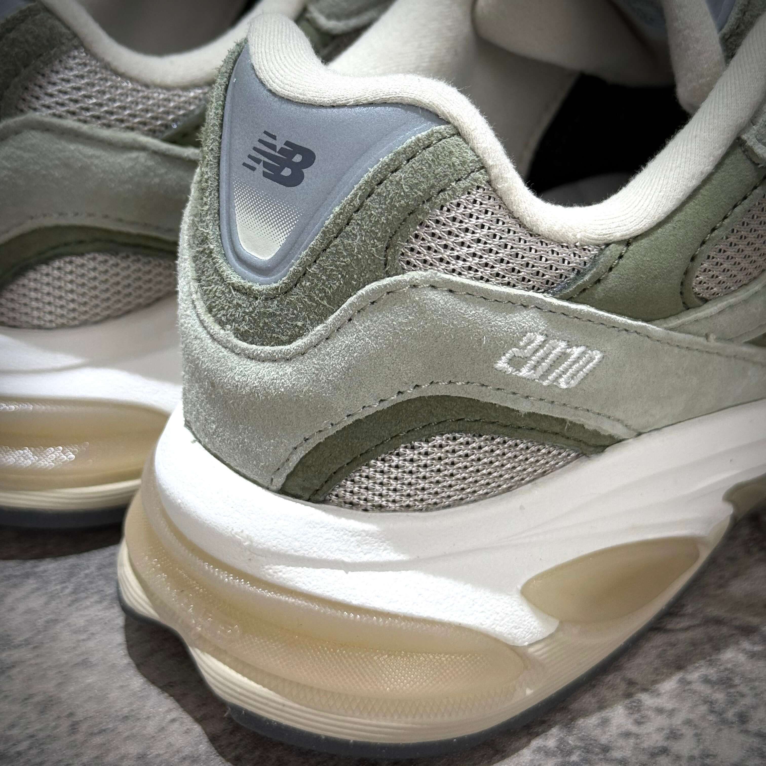 Close-up of New Balance U20105K7 Wasabi Green sneaker showing rear details and textures.