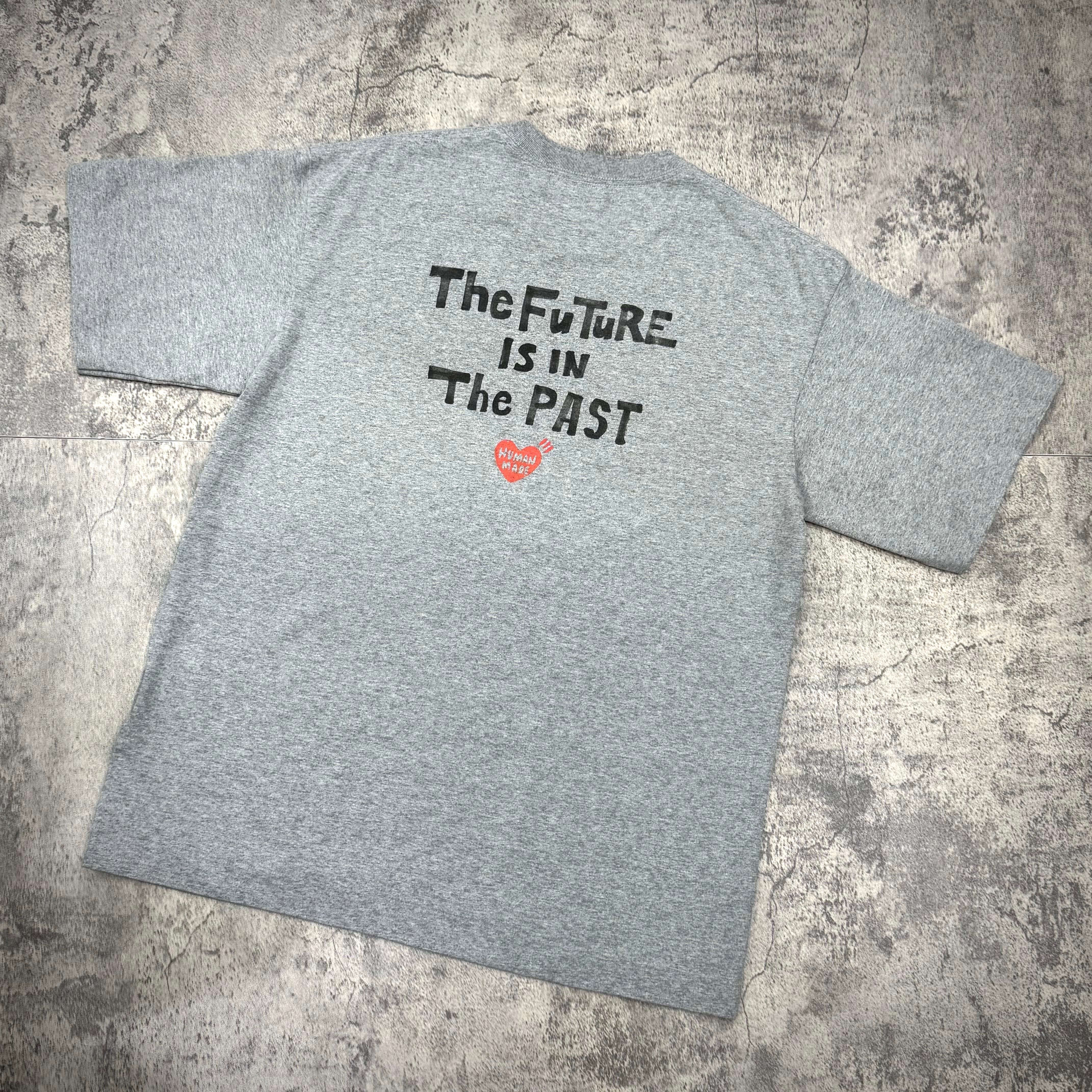 Human Made Graphic Tee HM31CS009 featuring the text 'The Future is in The PAST' on the back.