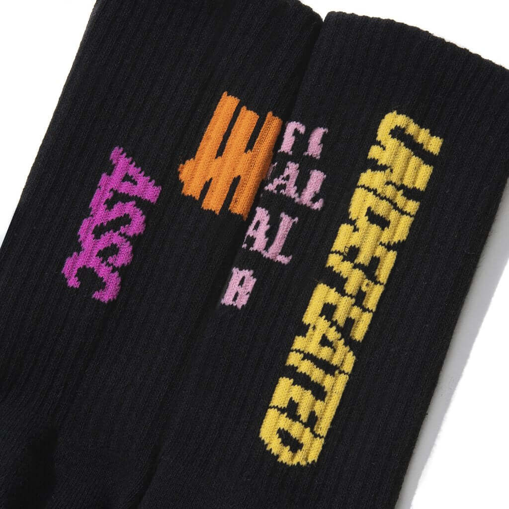 Anti Social Social Club x Undefeated Socks showcasing vibrant designs on a black background.