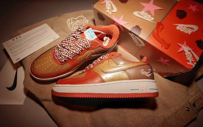 01 x Nigo x J-HOPE Nike Air Force 1 IO8766-800 featuring unique design and colors, displayed with packaging and informational card.