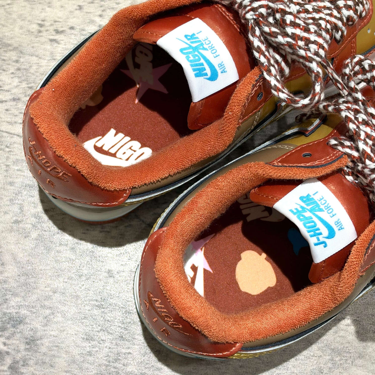 Interior view of 01 x Nigo x J-HOPE Nike Air Force 1 IO8766-800 sneakers showing unique design and logos.