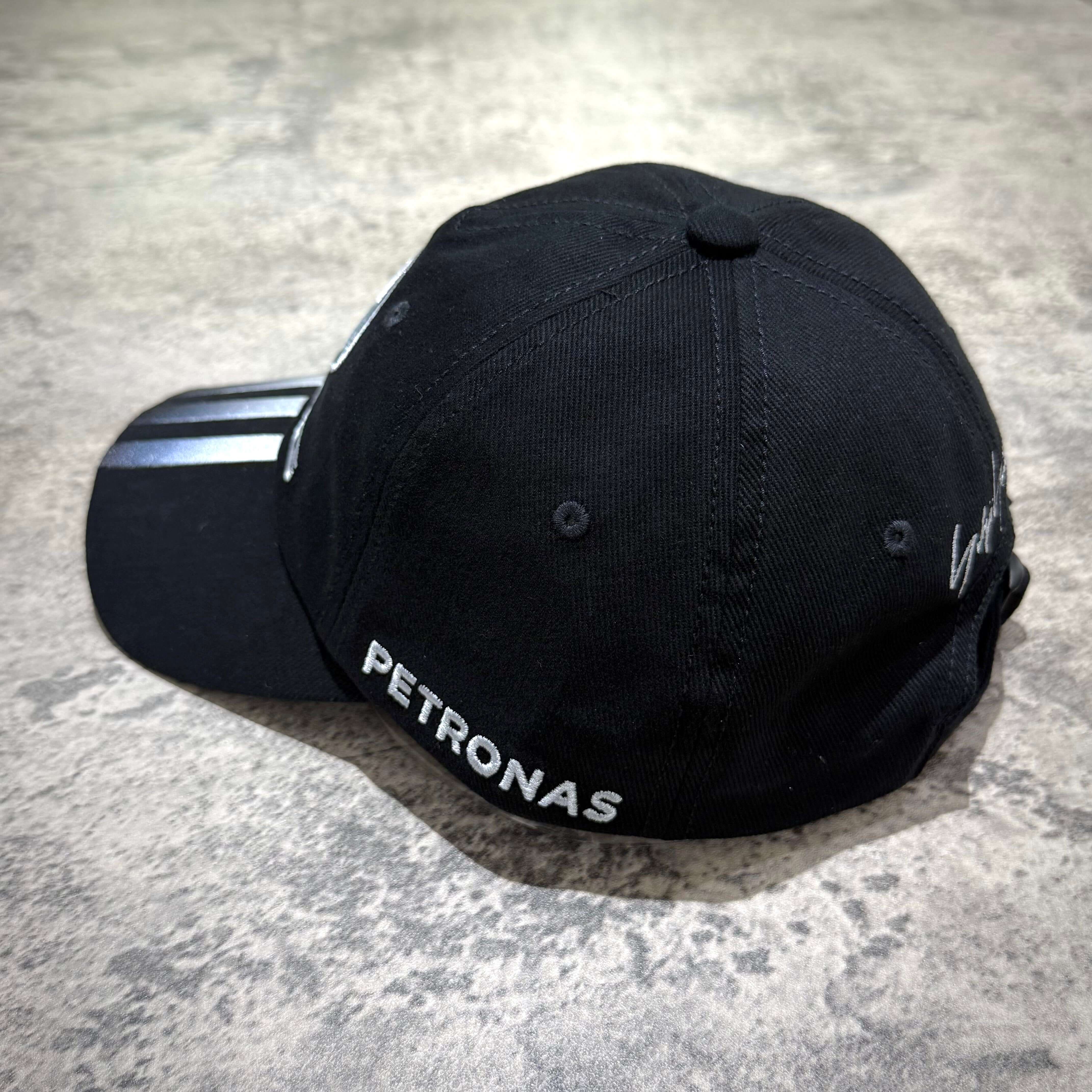 Y-3 x Mercedes AMG Petronas F1 Dad Cap with embroidered Petronas logo, stylish black design, side view.