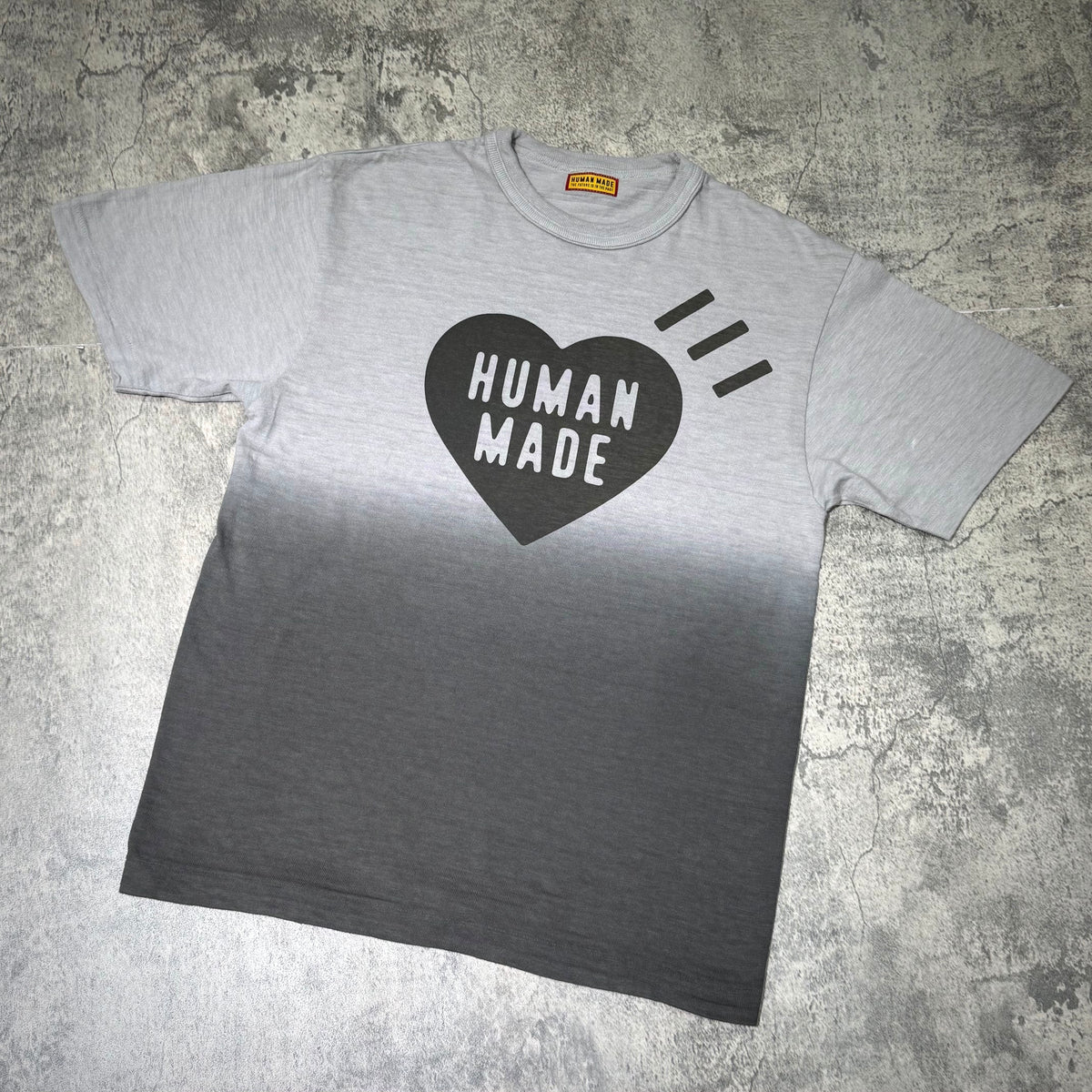 Human Made Tokyo Exclusive Gradation Tee featuring a heart design in black and a gray ombre effect.