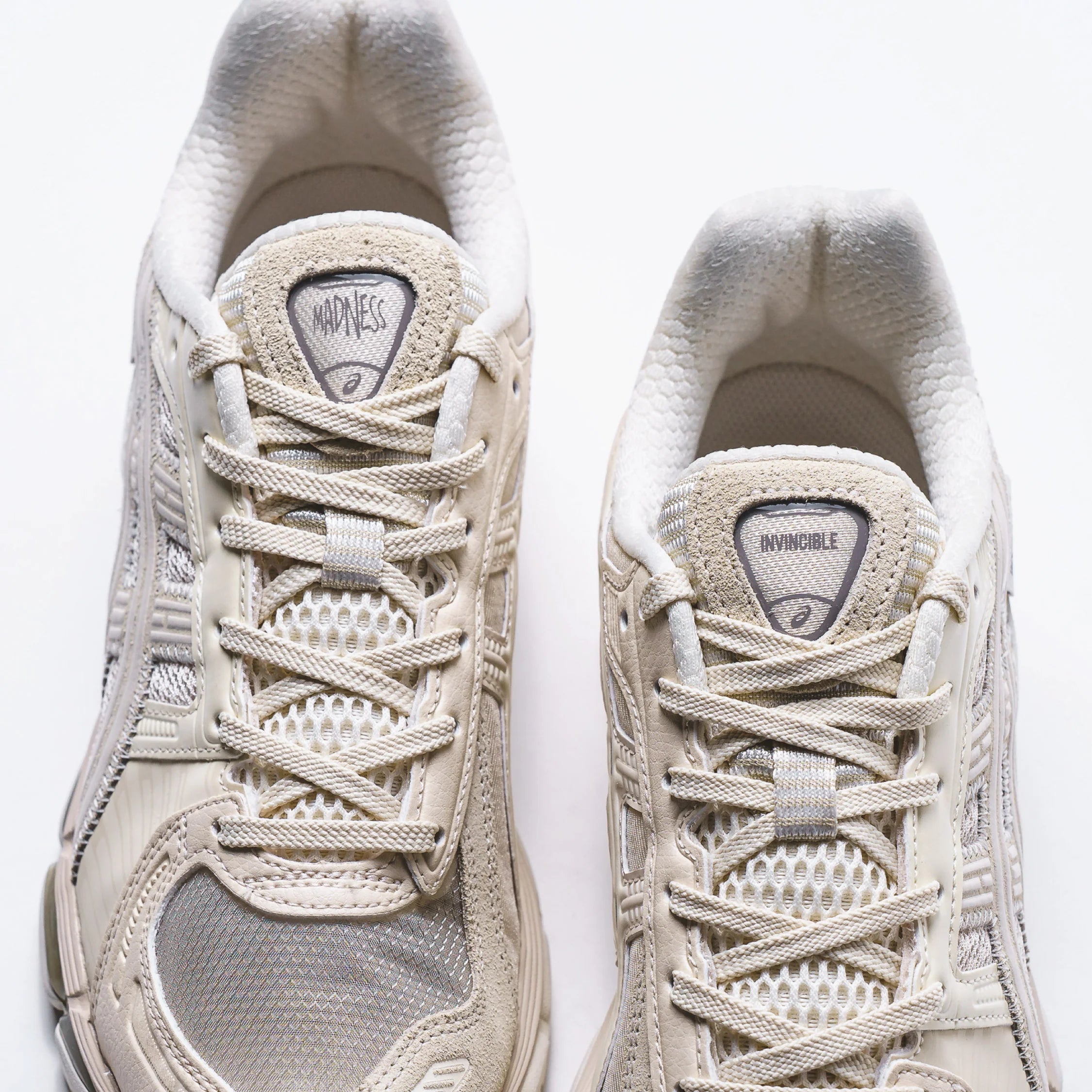 Madness x Invincible x Asics Gel-Kayano 12.1 Vanilla close-up view of the shoe's laces and logos.