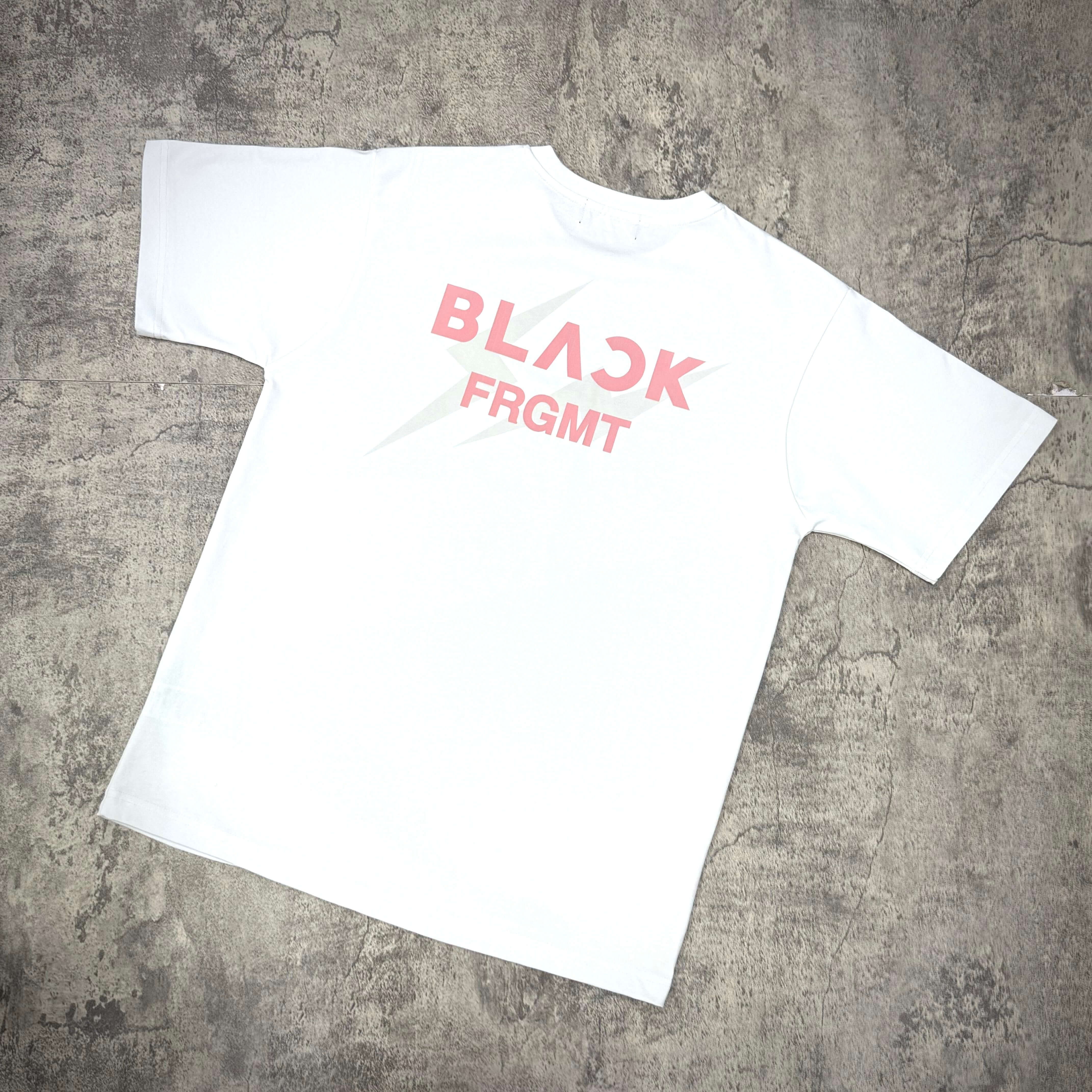 Fragment x Blackpink BLACKFRGMT Tee in white with bold pink lettering on the back.