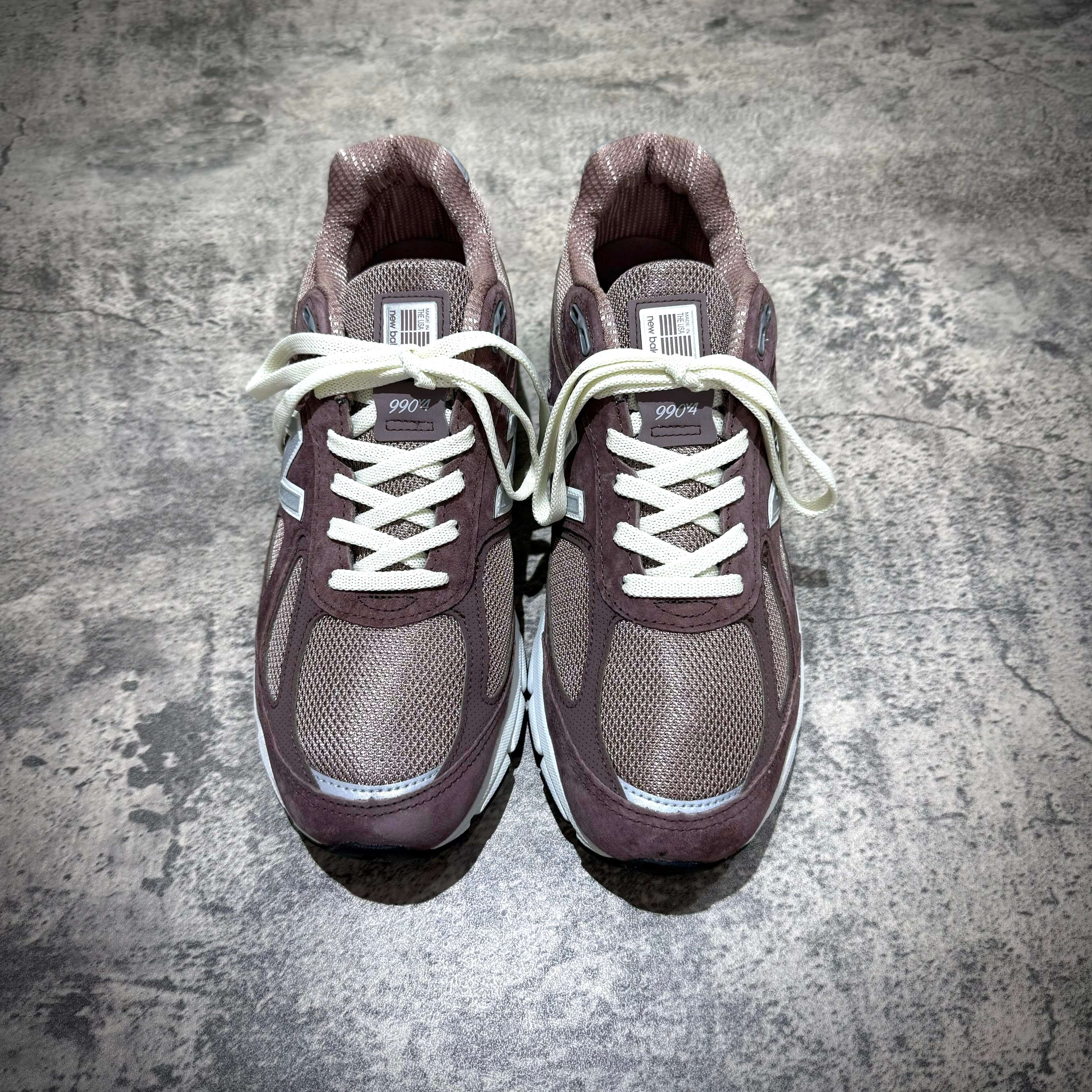 MiUSA Kith x New Balance 990v4 Dusty Mauve sneakers from top view, showcasing unique design and color.
