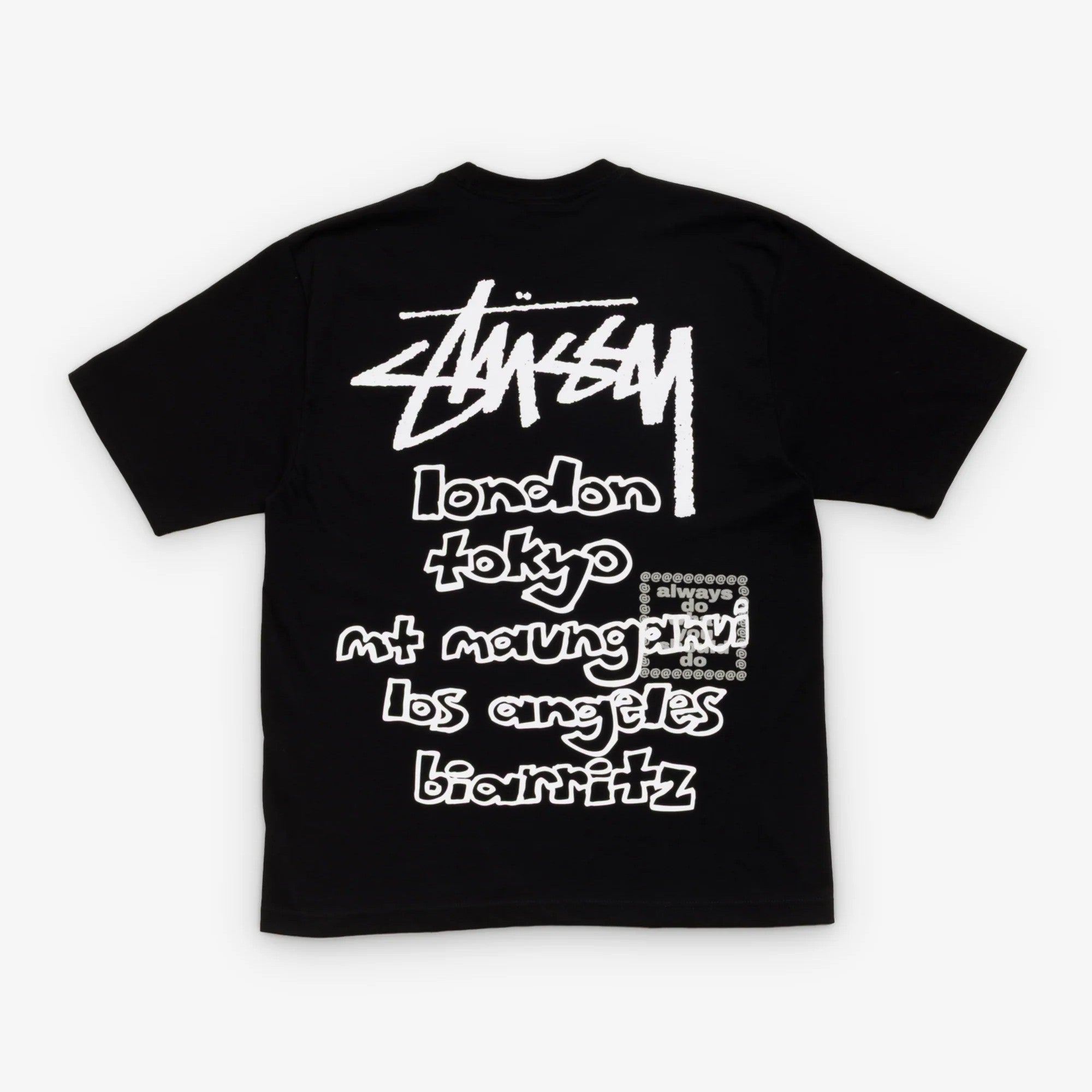 Stussy x Always Do What You Should Do World Tour Tee features city names on black fabric, showcasing the brand's global influence.