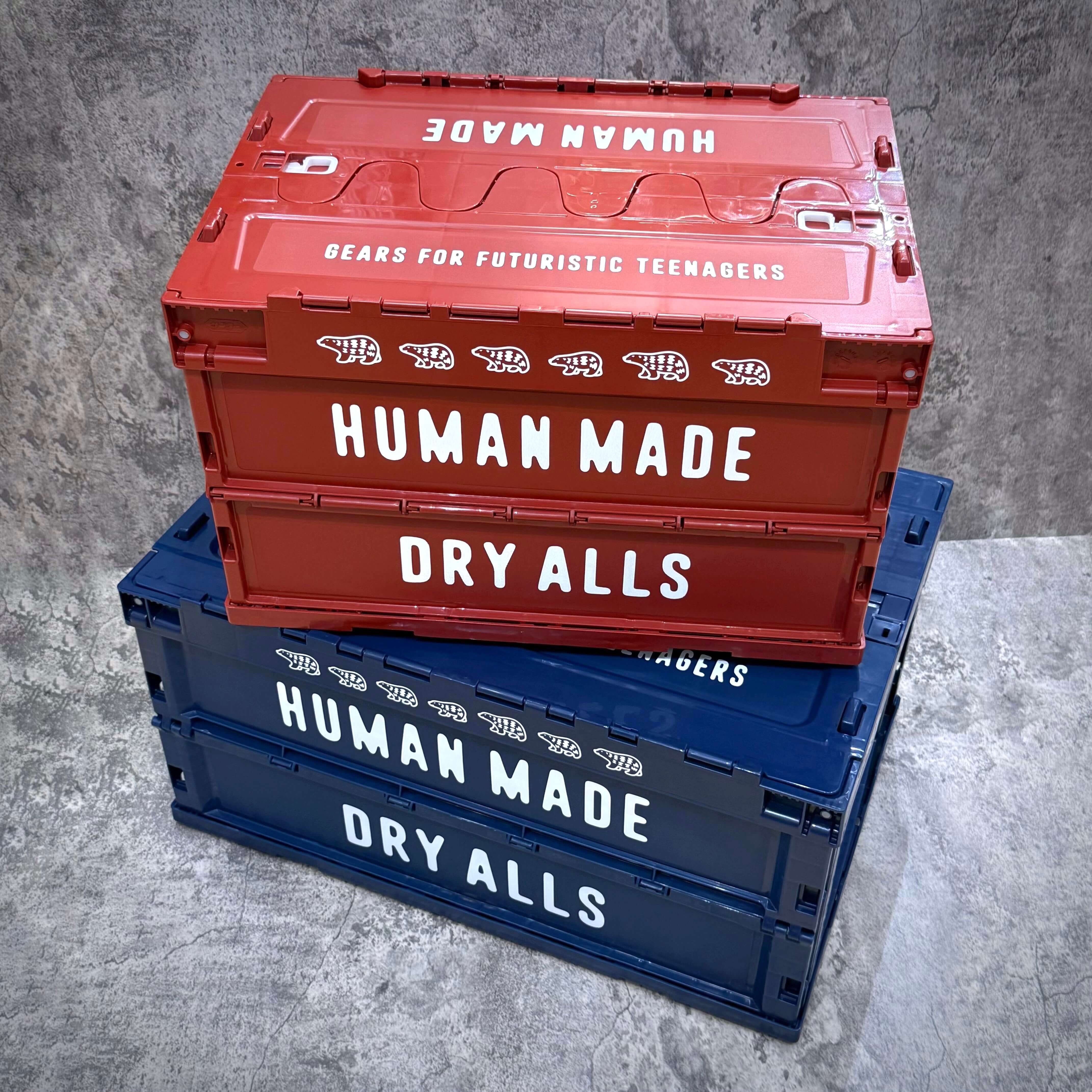Stack of red and blue Human Made Containers with text 'DRY ALLS' and 'BEARS FOR FUTURISTIC TEENAGERS'.