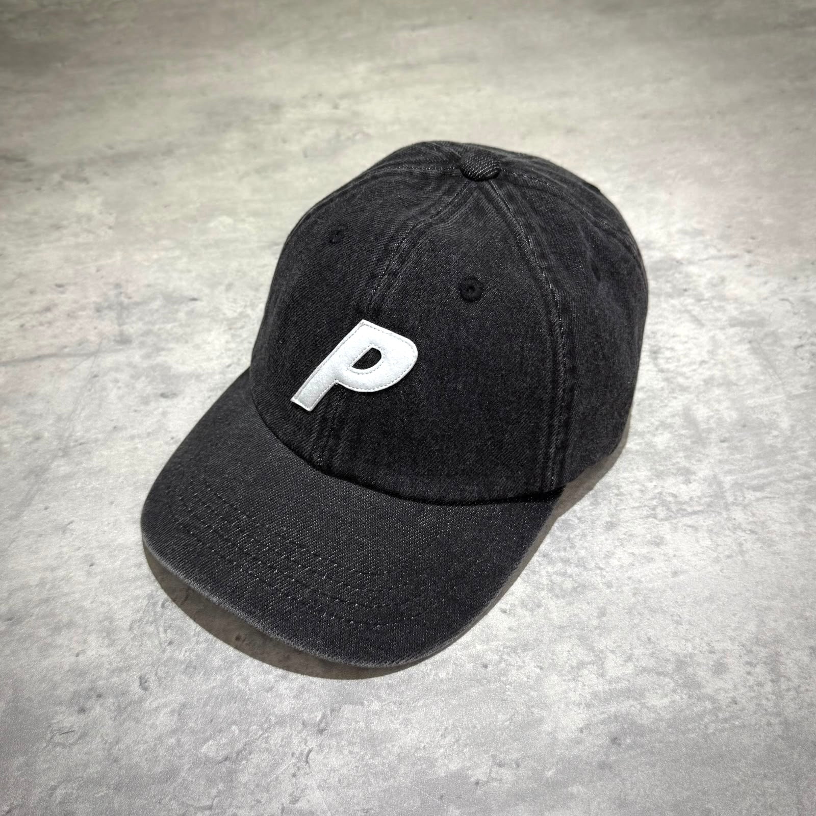 Palace Demin P 6 Panel - Black hat featuring a white "P" logo on the front, perfect for casual wear.