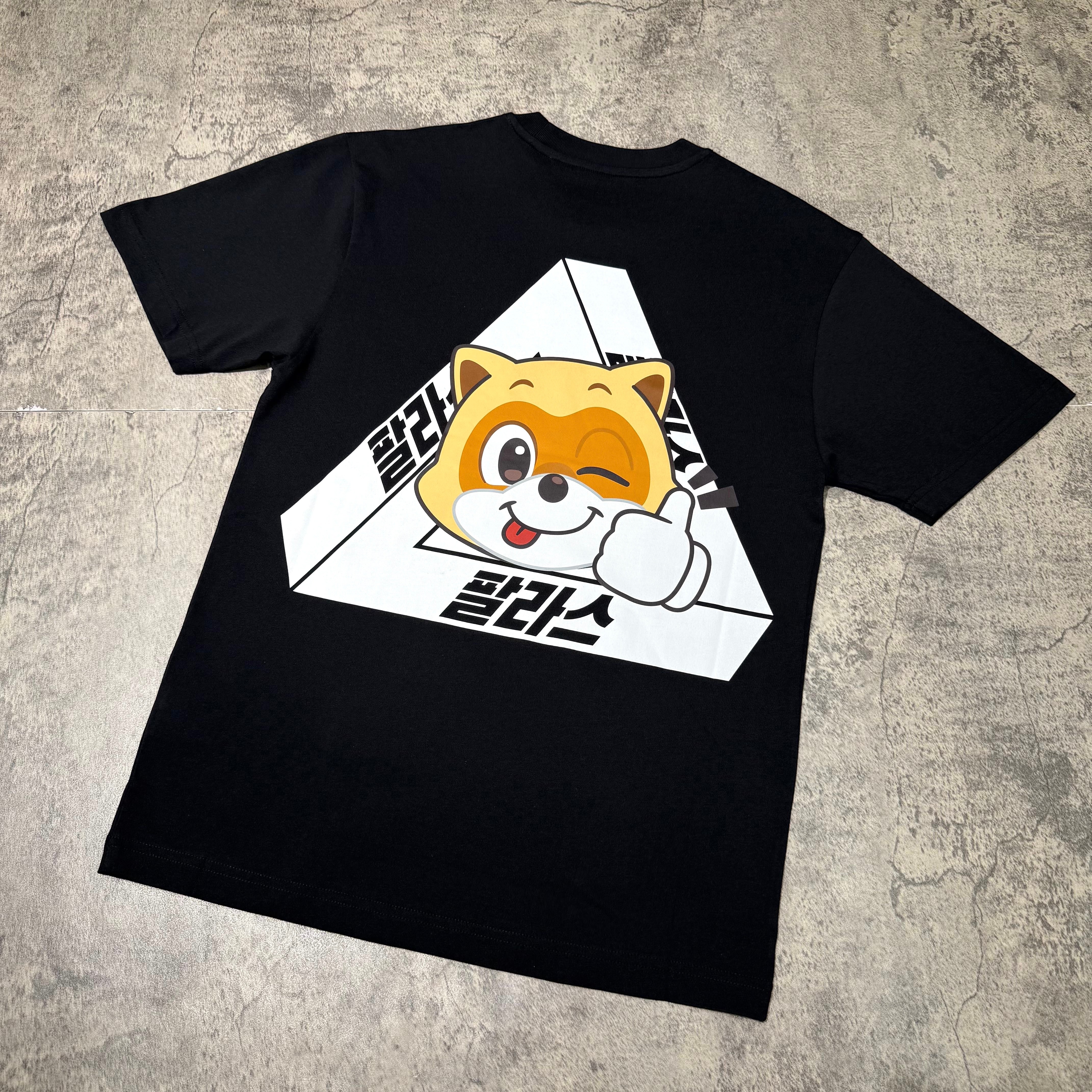 Back view of a black Palace Jamsil Exclusive Lotte Tri-ferg Tee featuring a cartoon dog design.