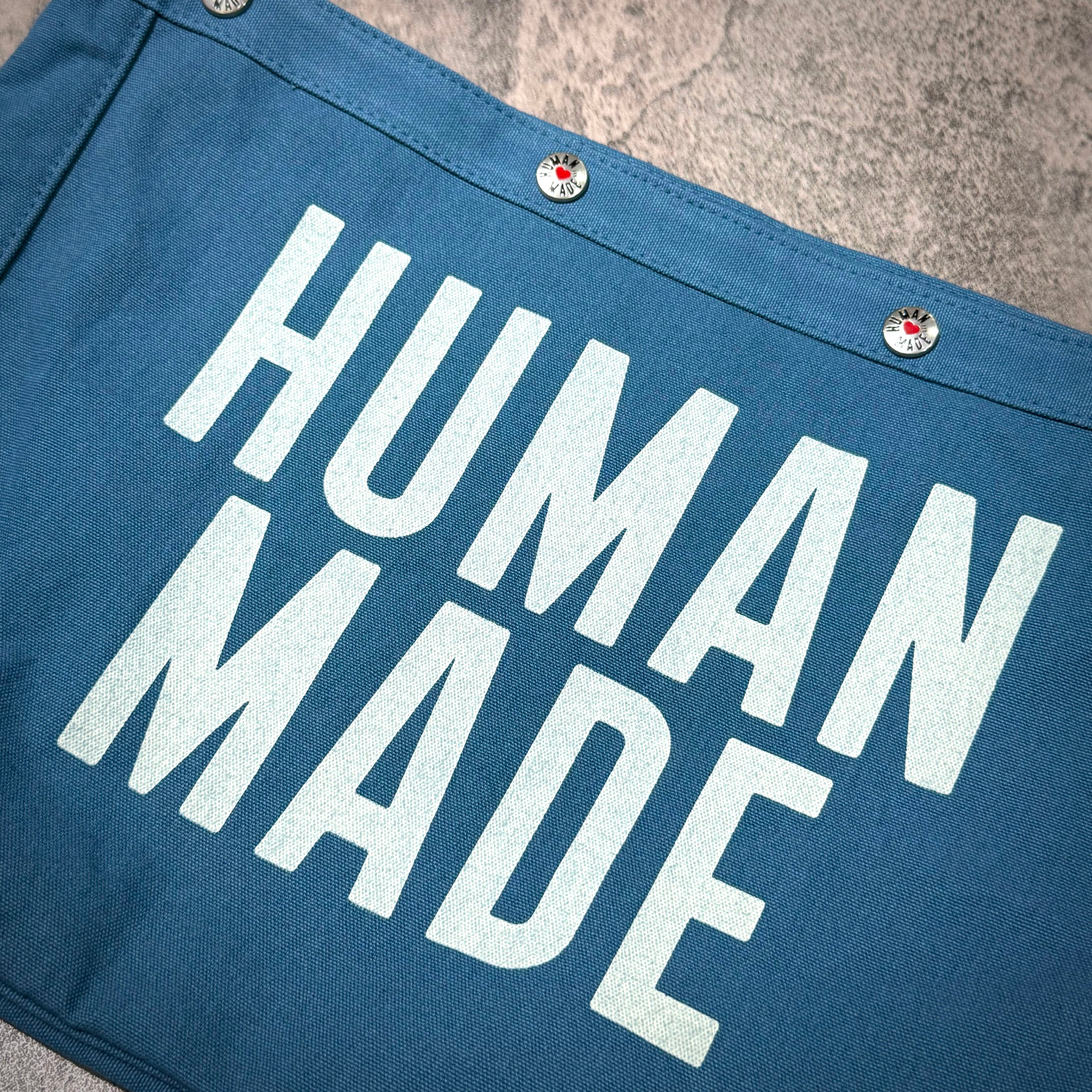 Human Made Paper Boy Bag with bold 'HUMAN MADE' text on a blue background.