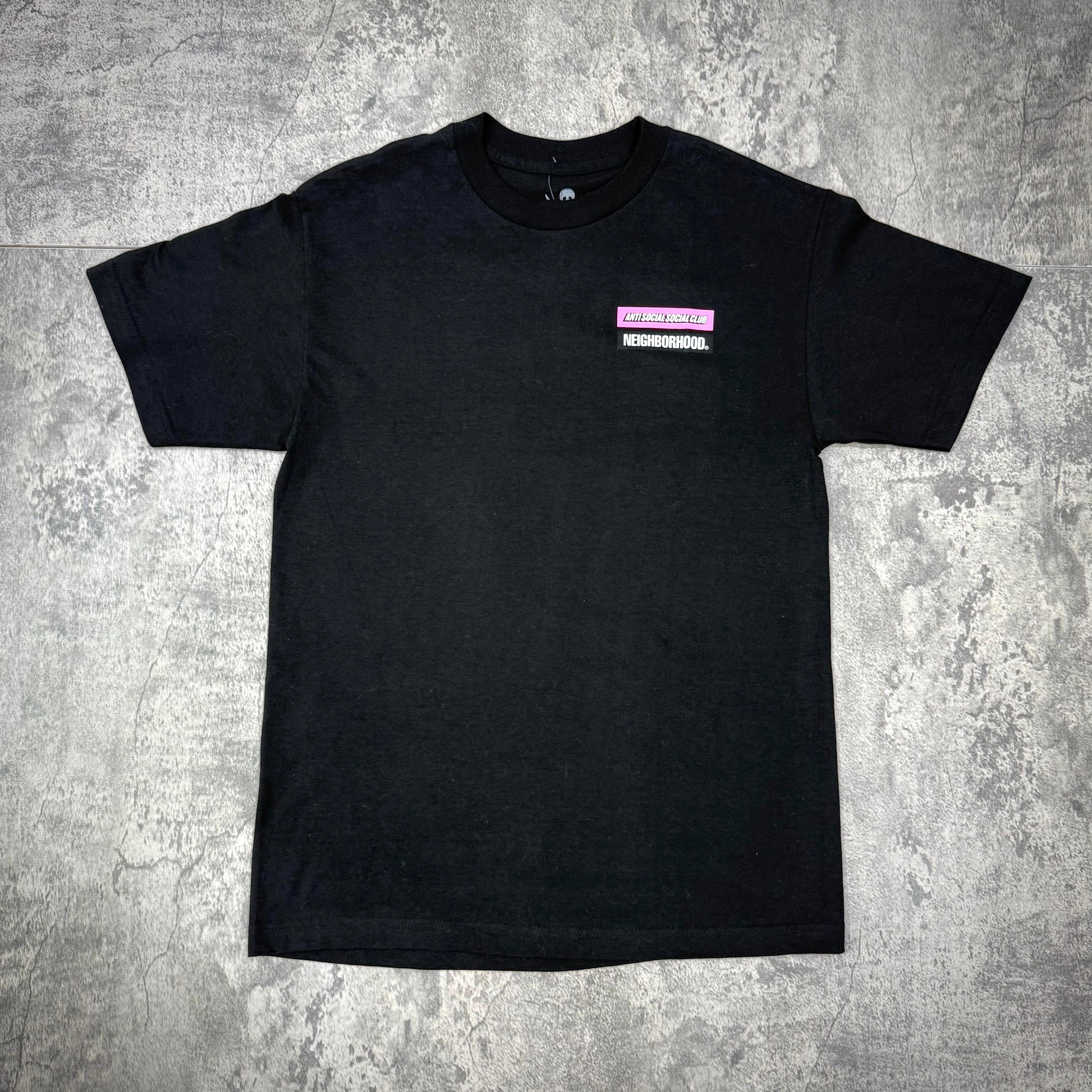 ASSC x Neighborhood Stuck On You Tee - Black / White displayed on a gray surface, showcasing its front design.