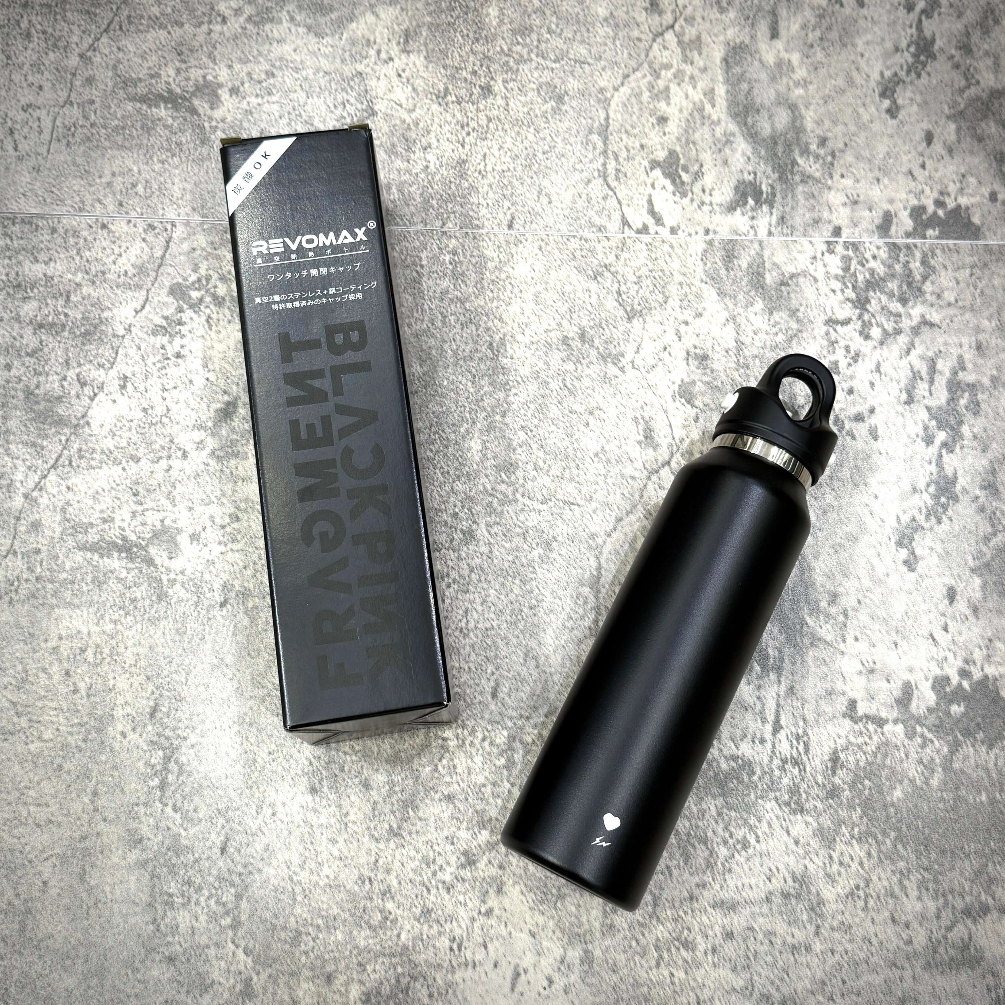 Fragment x Blackpink REVOMAX 16oz Carbonated Tumbler in packaging on a gray surface.