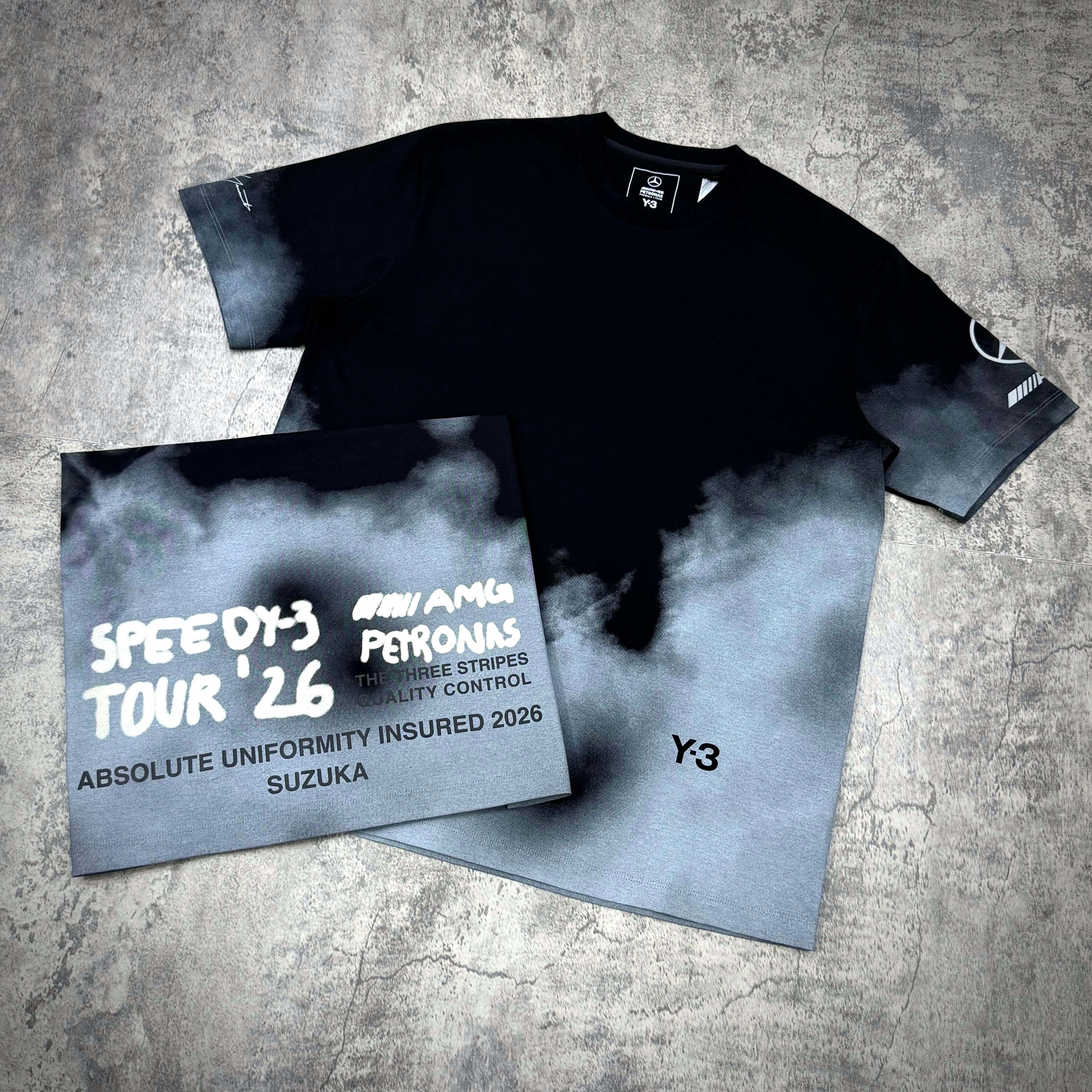 Y-3 x Mercedes AMG Petronas F1 Tour Tee displaying shirt and packaging with cloud design.