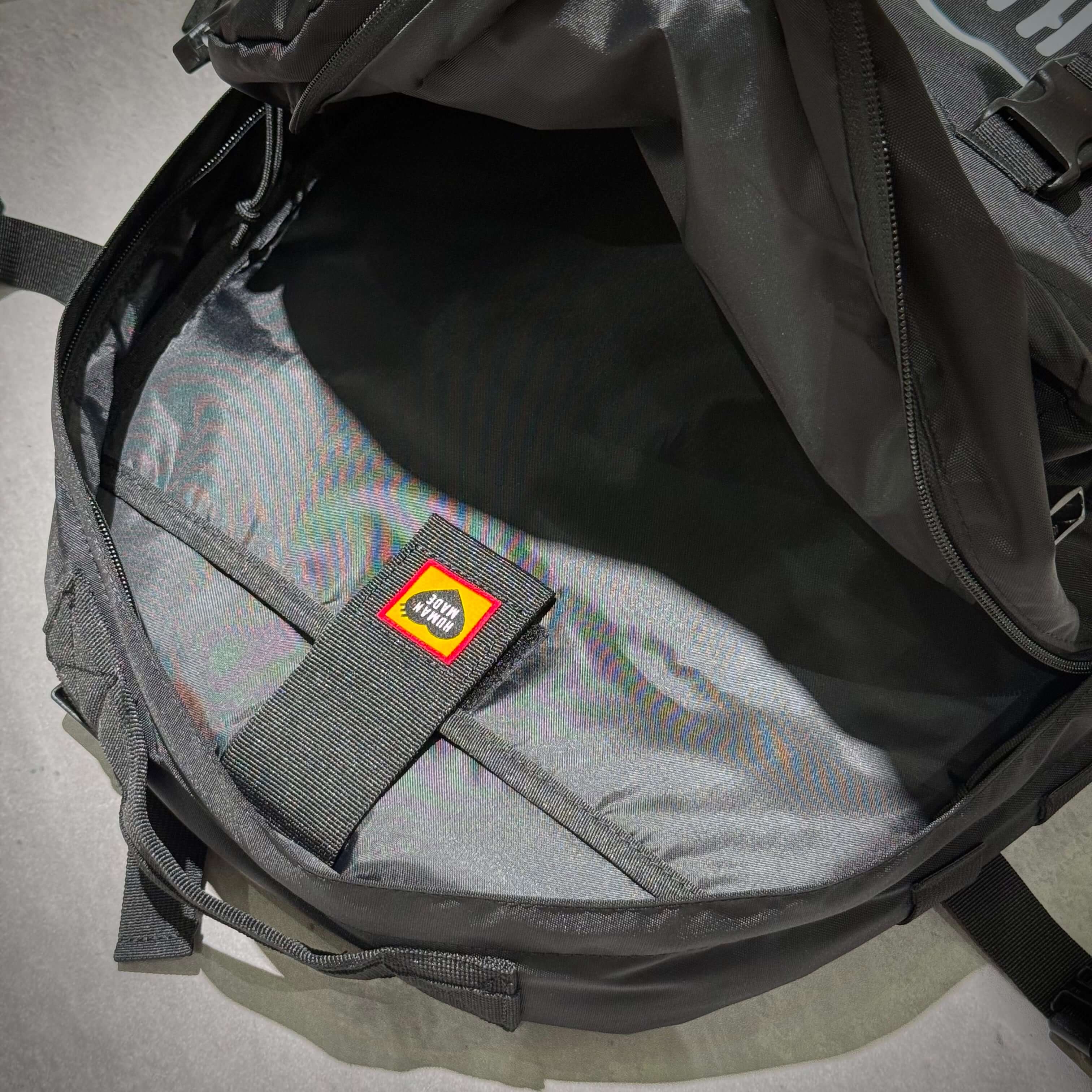 Inside view of the Human Made Military Backpack HM32GD008 showcasing its spacious interior and brand label.