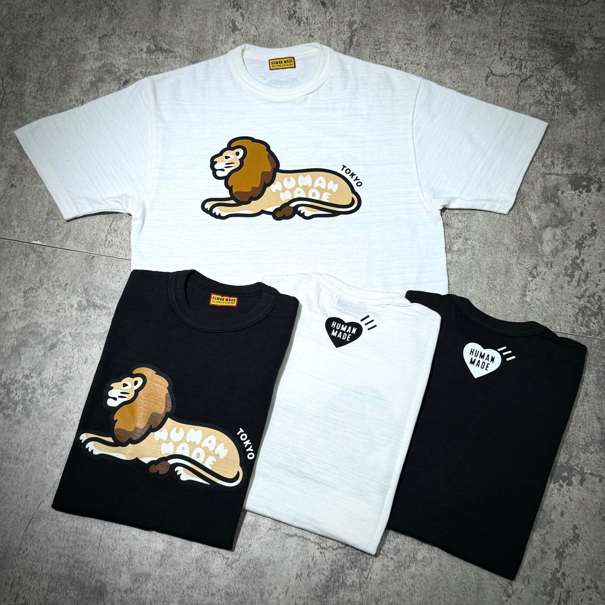 Human Made Tokyo Exclusive Lion Tee displayed in black and white colors with lion graphic.