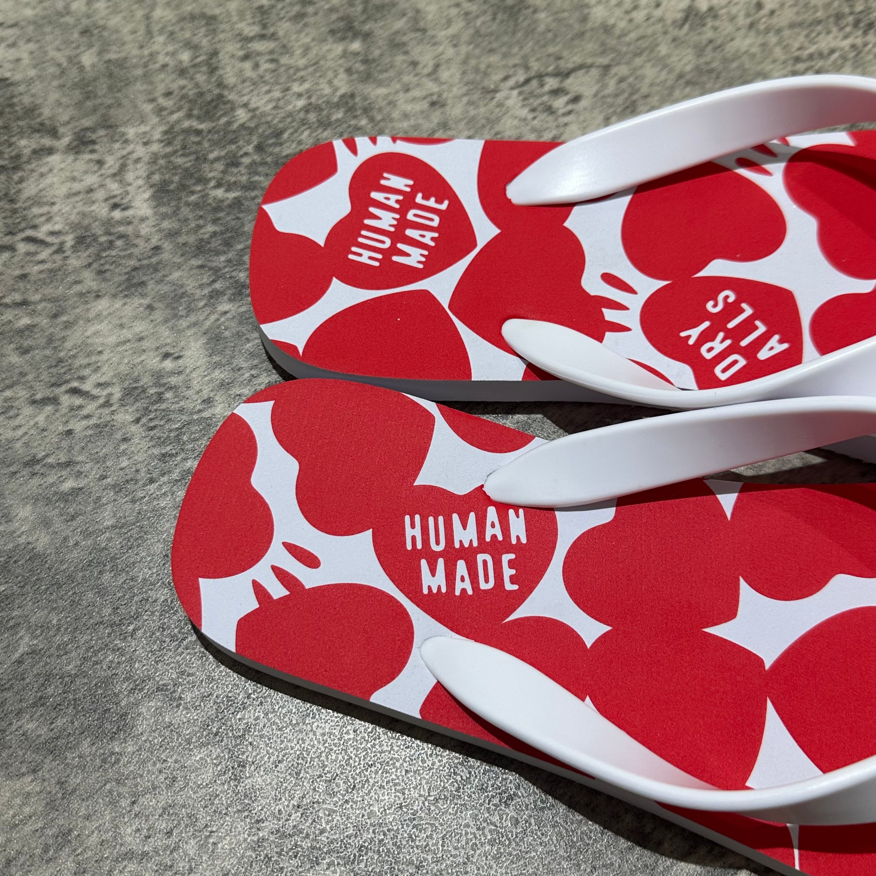 Close-up view of Human Made Sandal featuring red heart patterns and white straps, showcasing the unique design.