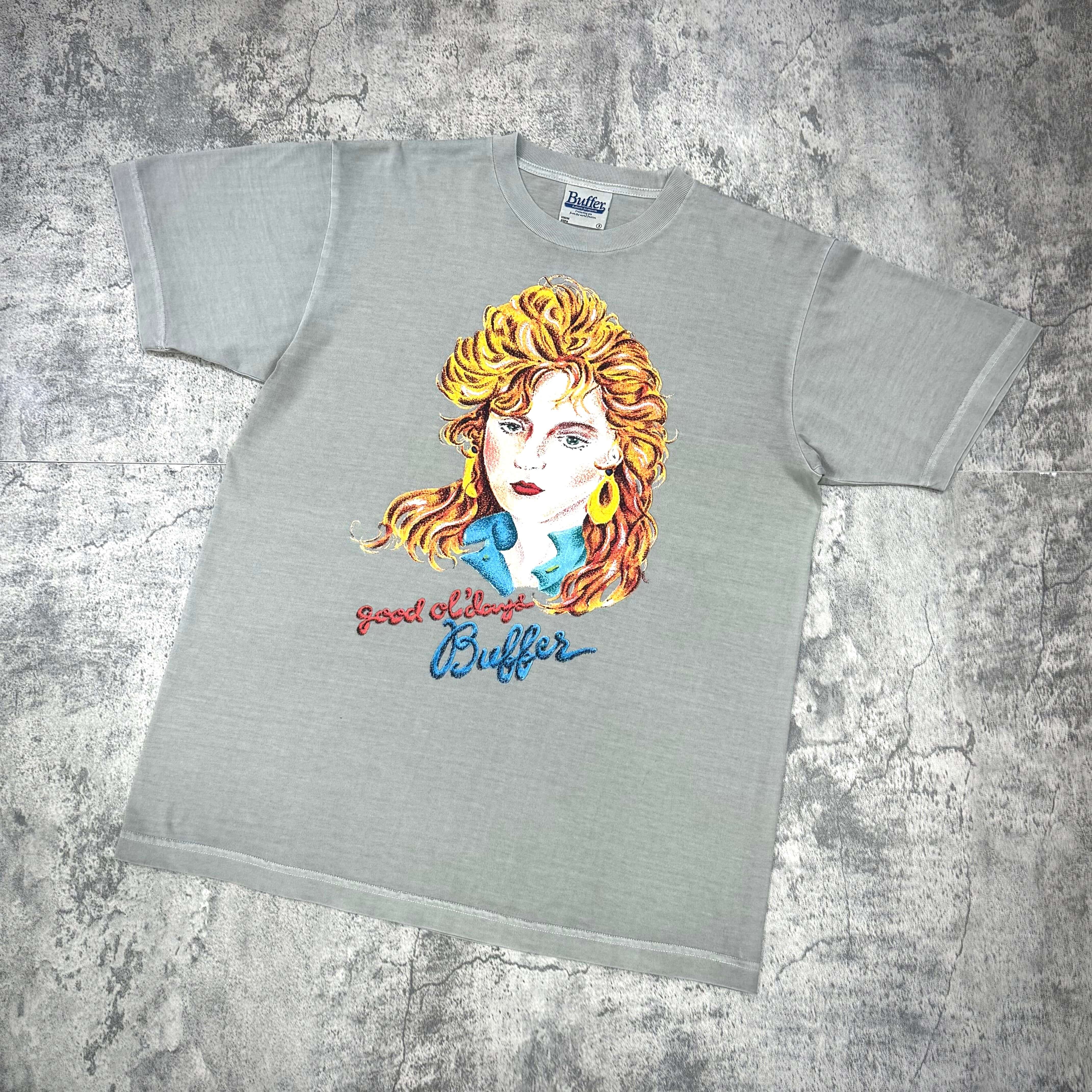 Buffer Groupie Tee featuring a colorful graphic design of a woman on a light grey t-shirt.