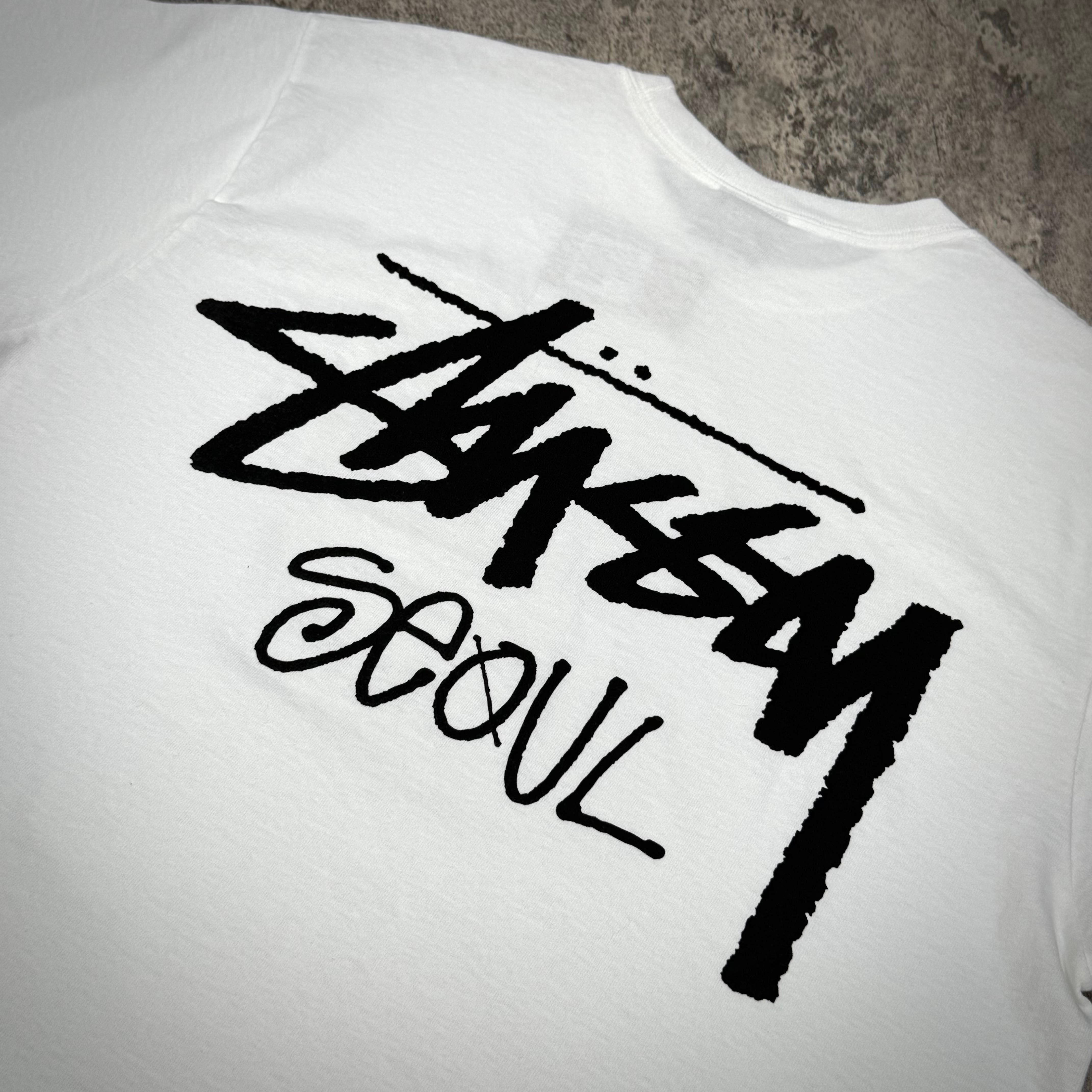 Stussy Seoul logo on the back of a white tee shirt showcasing exclusive design elements.
