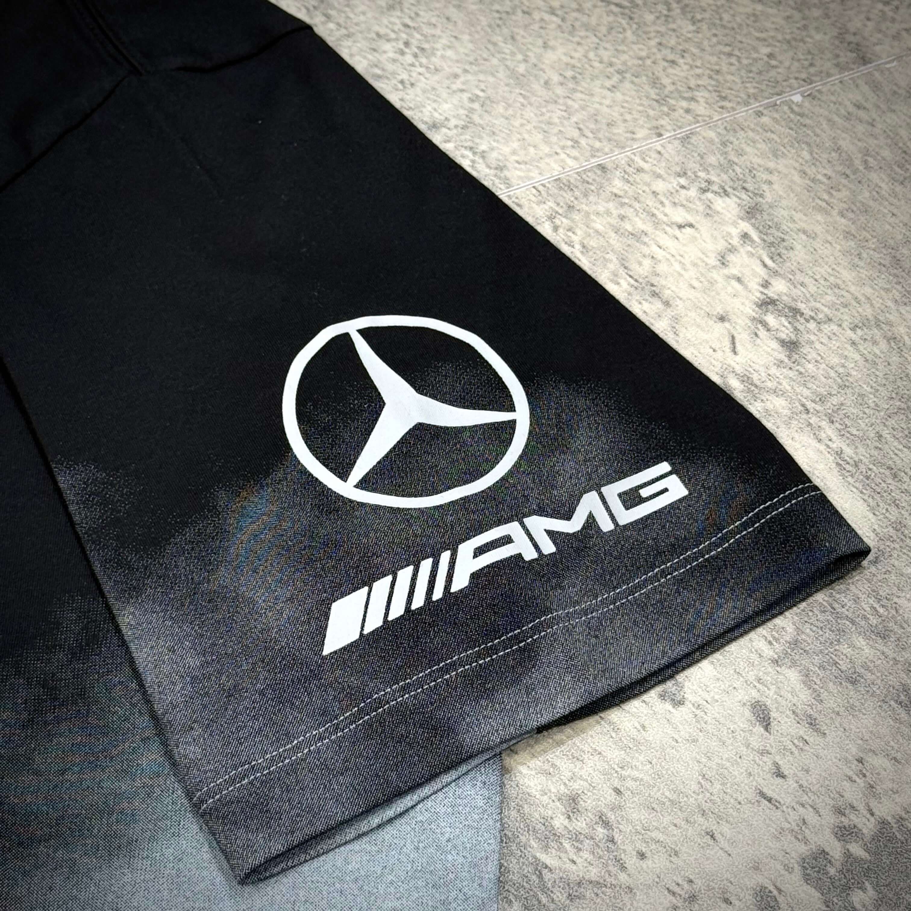 Close-up of the Y-3 x Mercedes AMG Petronas F1 Tour Tee showcasing the Mercedes logo and AMG branding.