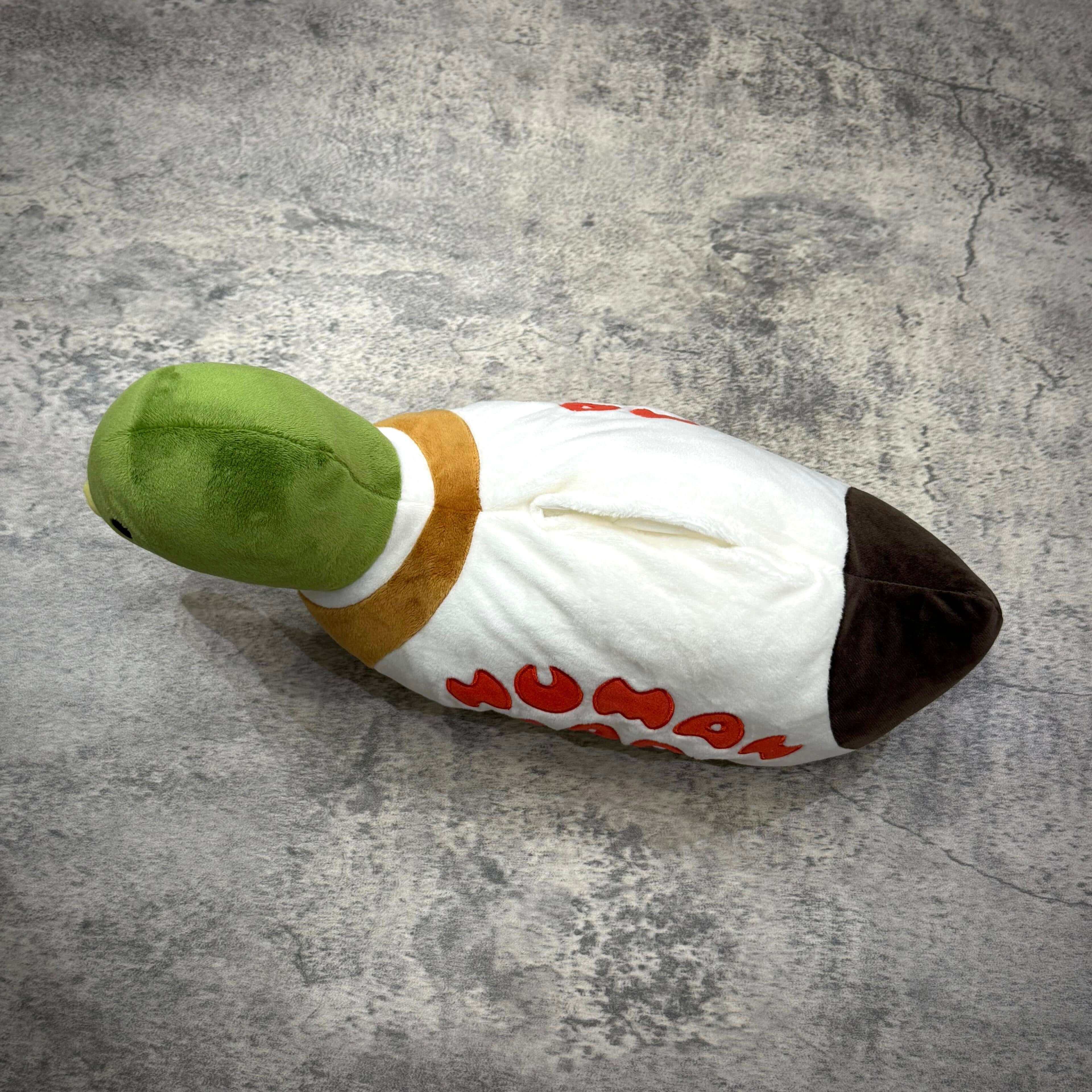 Human Made Duck Plush Doll Tissue Case shown from above on a textured surface.