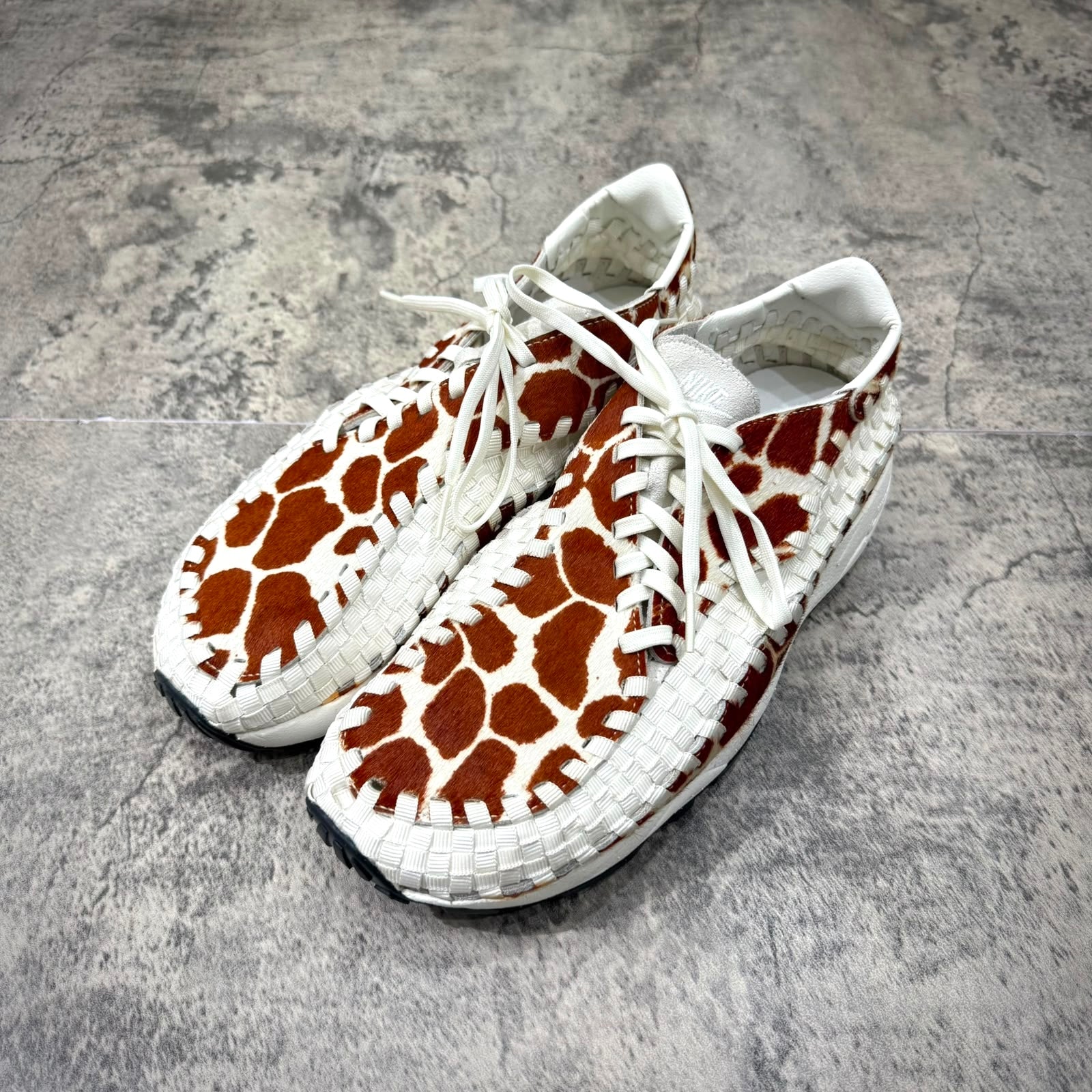 Nike Air Footscape Woven Cow Print featuring a unique cow print design, perfect for casual and stylish wear.