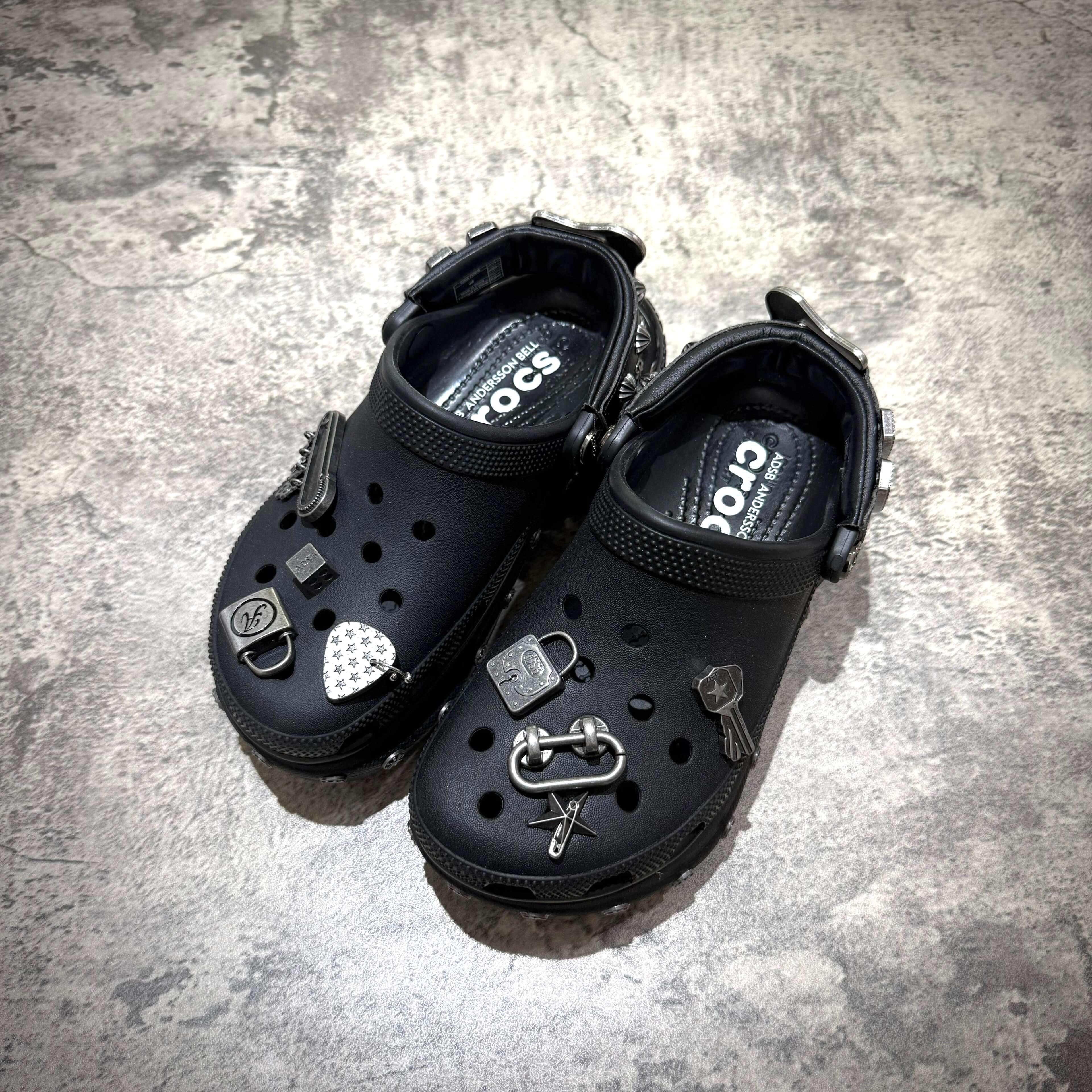 ANDERSSON BELL x Crocs Bae Clog featuring a stylish black design and decorative charms, perfect for trendy footwear enthusiasts.