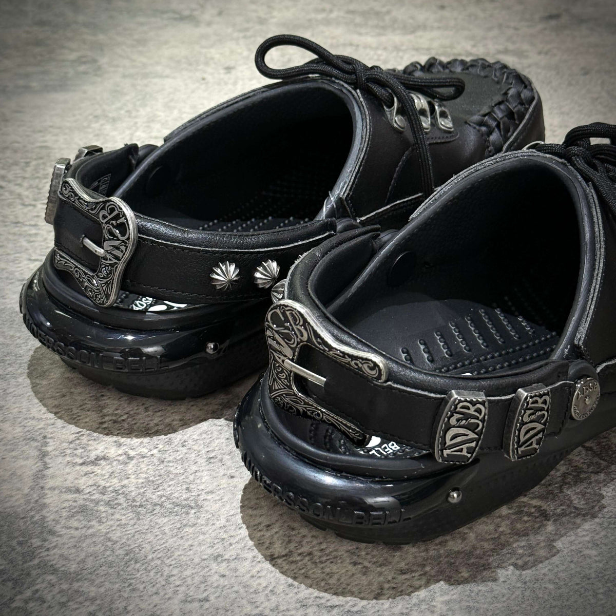 ANDERSSON BELL x Crocs Classic Clog in black with decorative buckles and design details on the side.