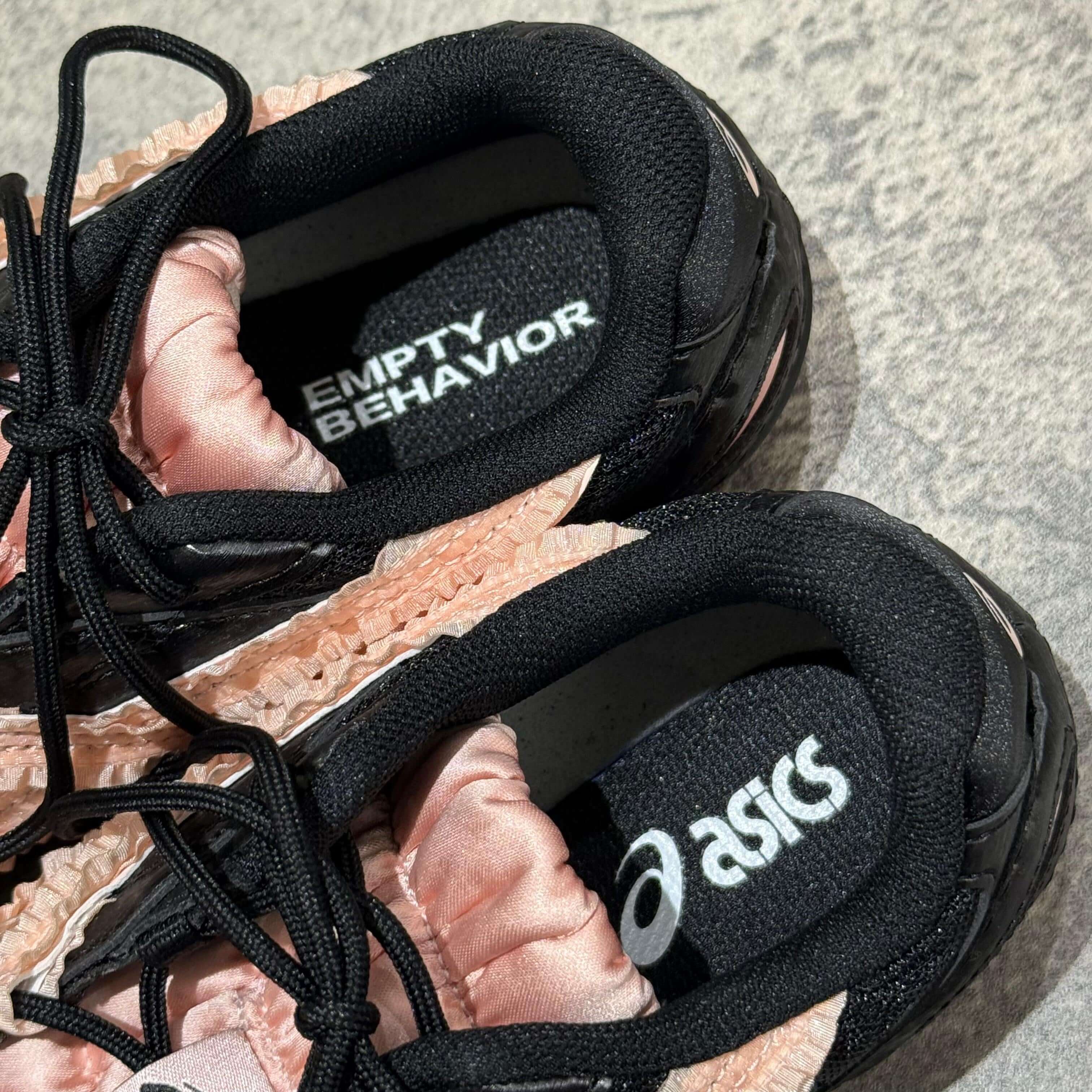 Asics x Empty Behavior Hypersync Black Breeze interior showing Empty Behavior logo and Asics branding.