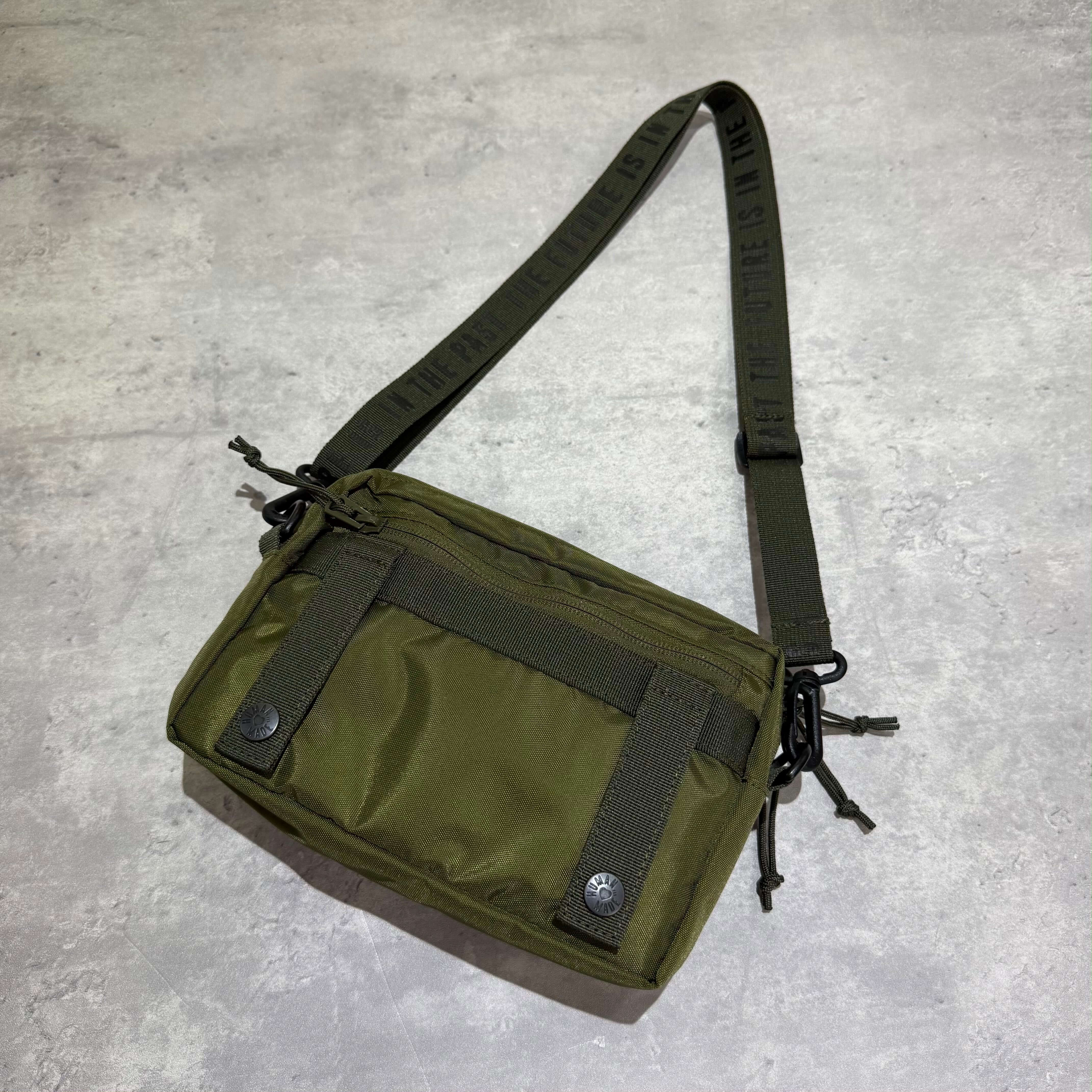 Human Made Military Pouch in green color with adjustable strap and multiple compartments, perfect for everyday use.