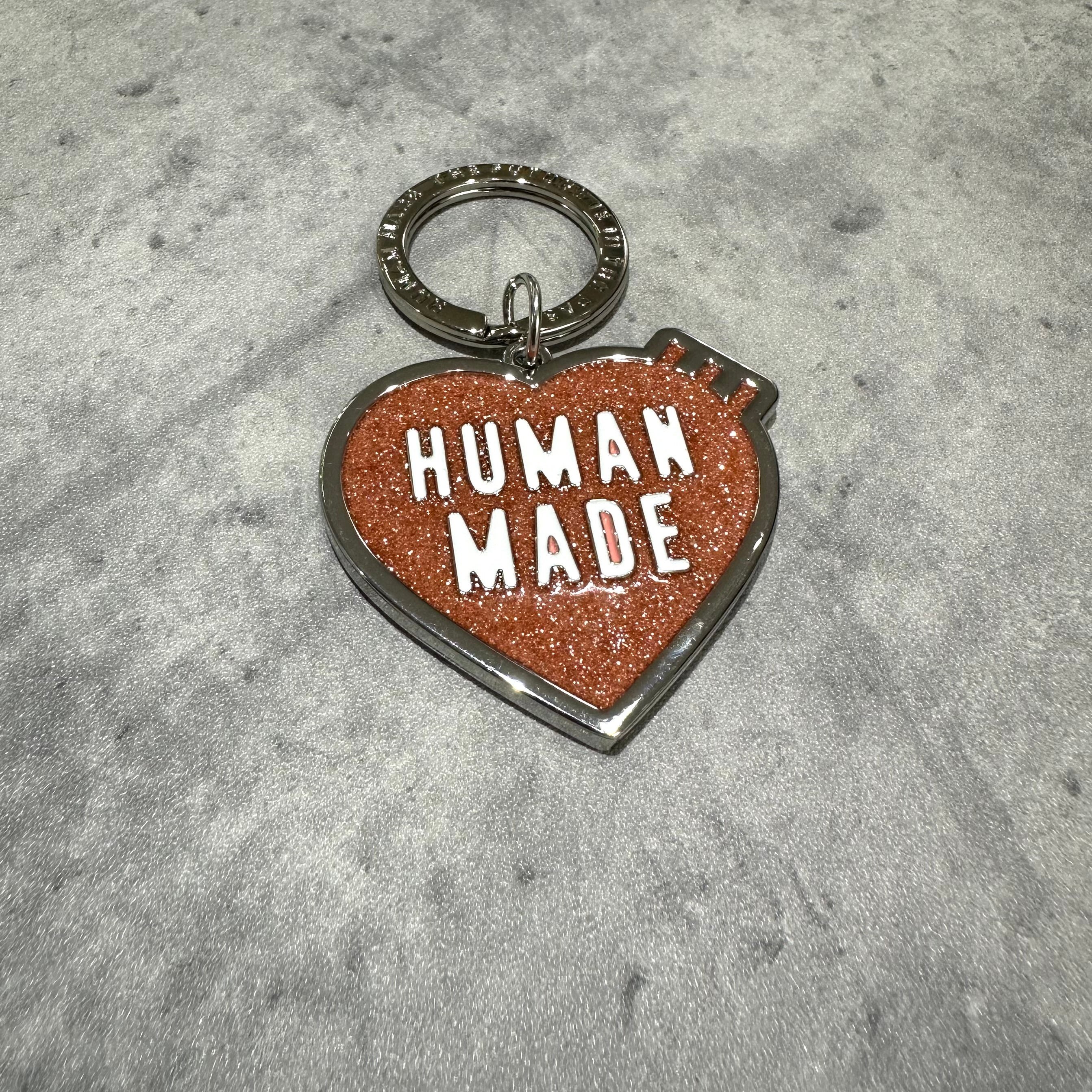 Human Made Store Exclusive Heart Keychain featuring a glittery red heart with white text on a silver keyring.