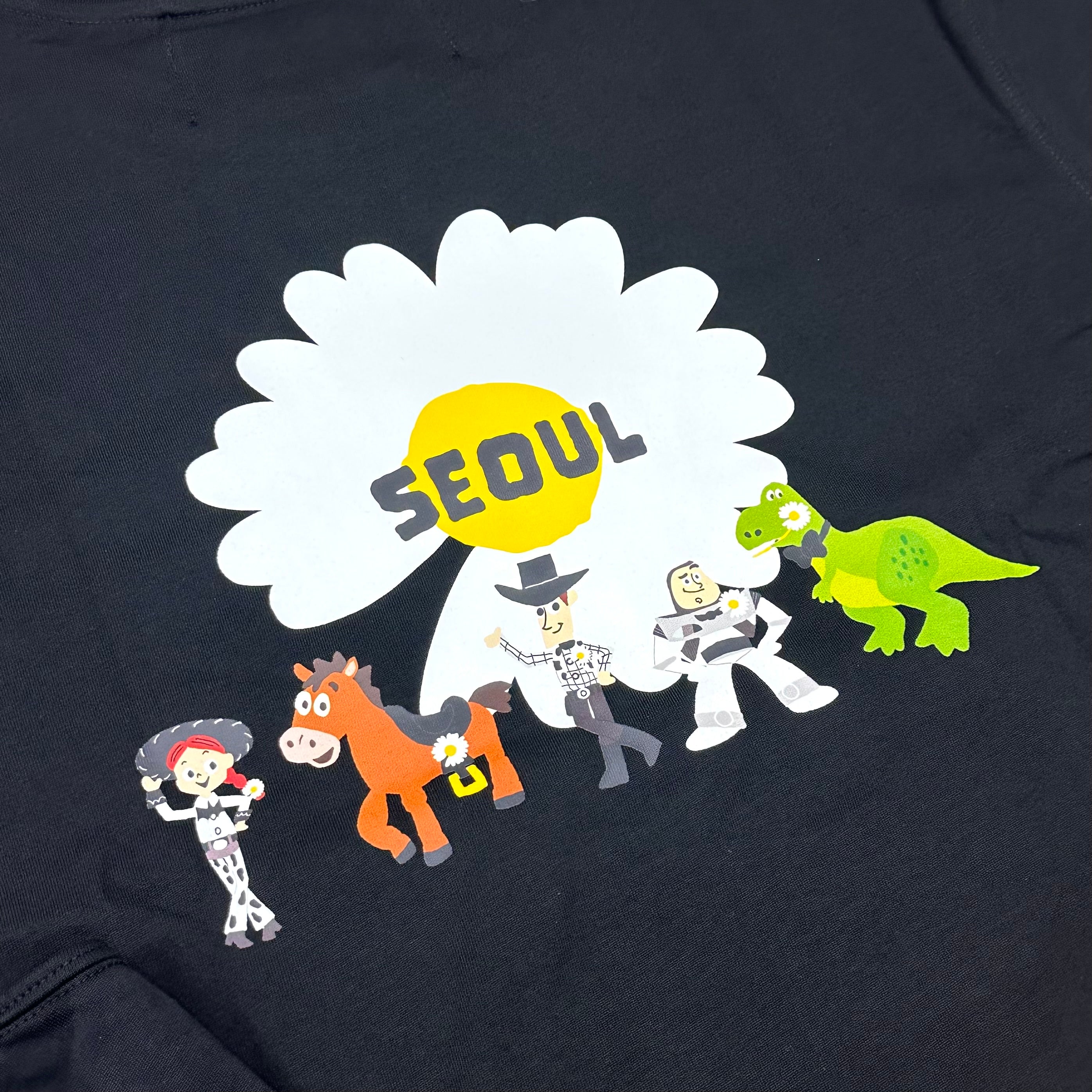 PEACEMINUSONE x Toy Story graphic T-shirt featuring characters and 'SEOUL' design
