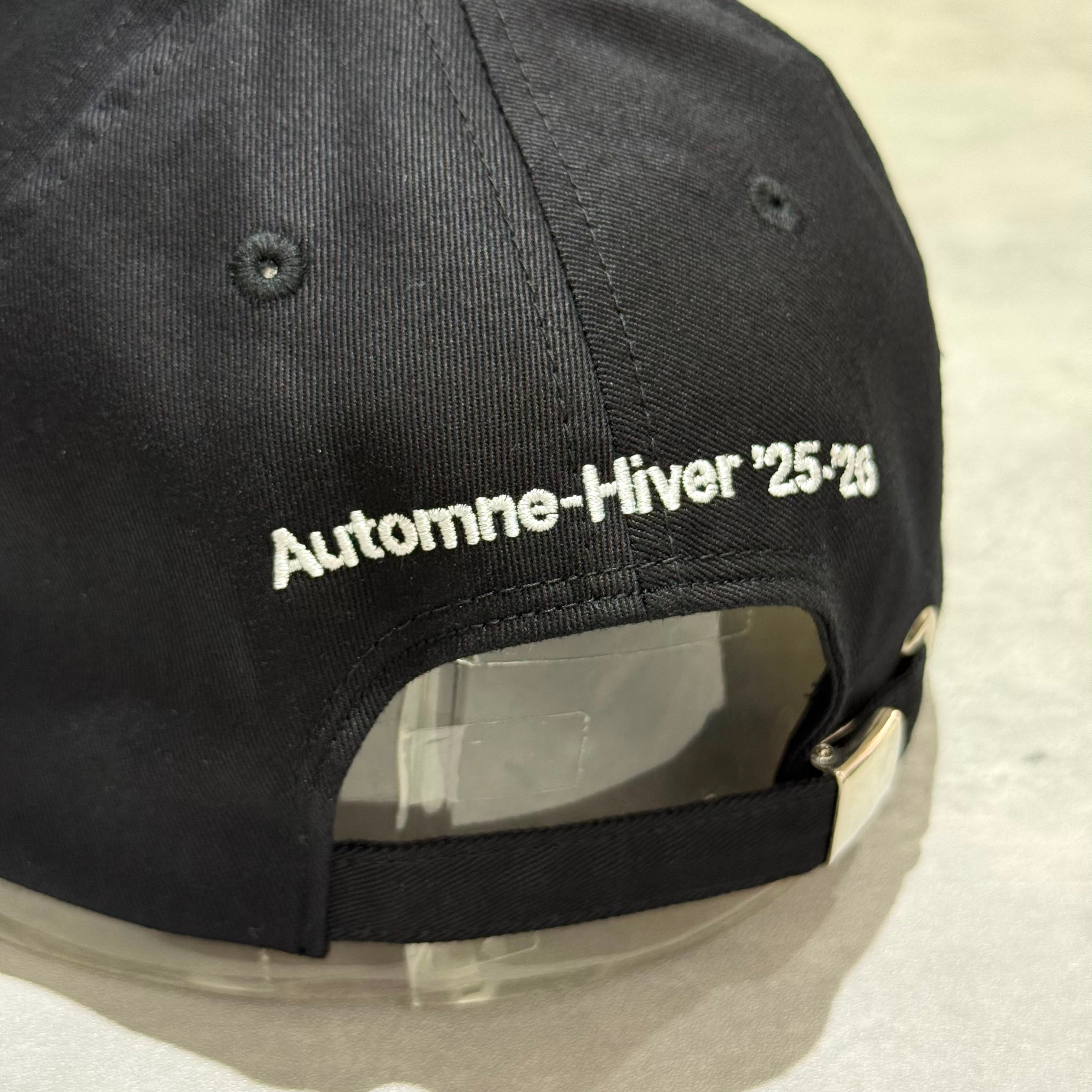Back view of CDG x G-DRAGON Ubermensch Classic Cap featuring embroidered 'Automne-Hiver 25-26' text.