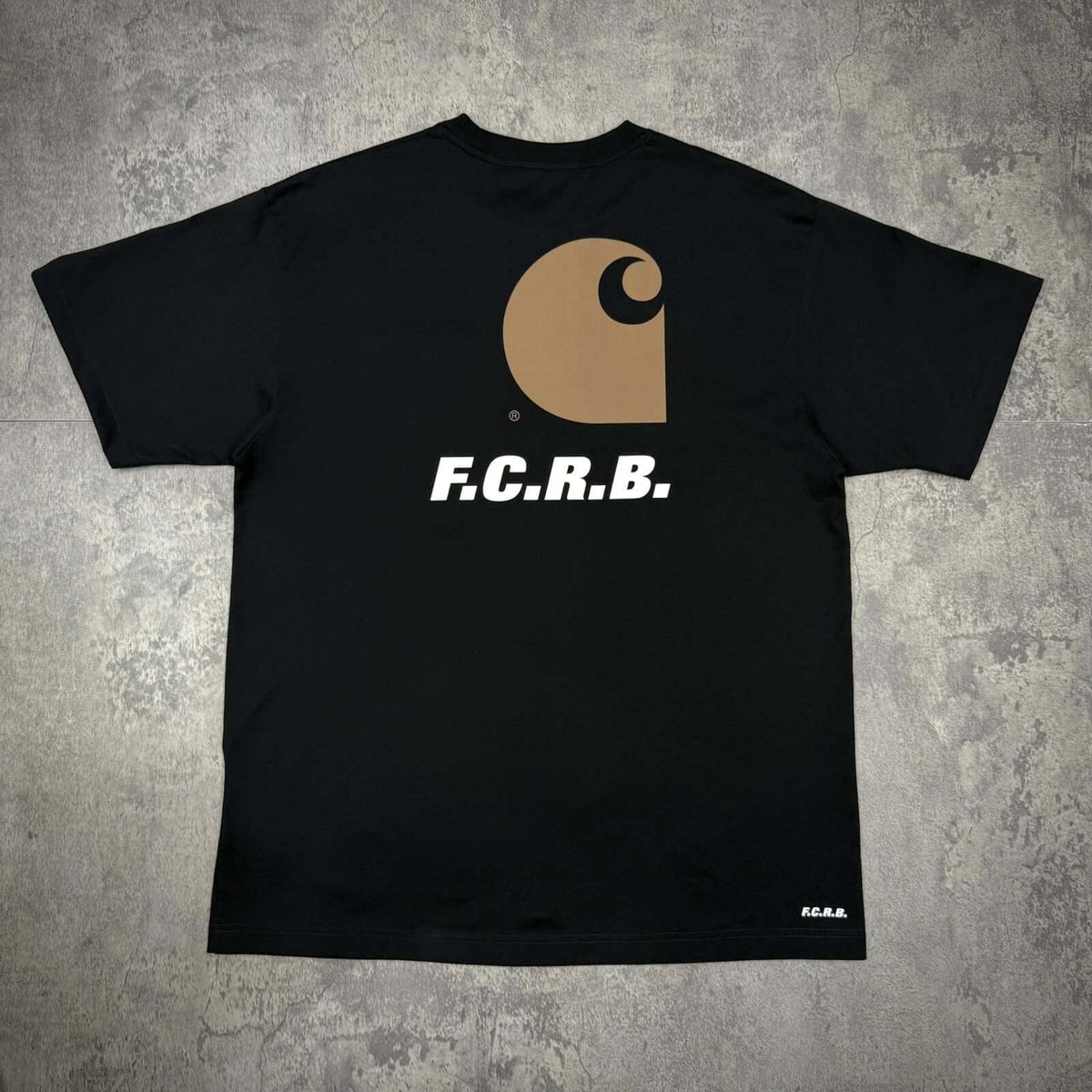 Carhartt WIP x F.C.Real Bristol Pocket Tee featuring a back design with F.C.R.B. logo on black fabric.