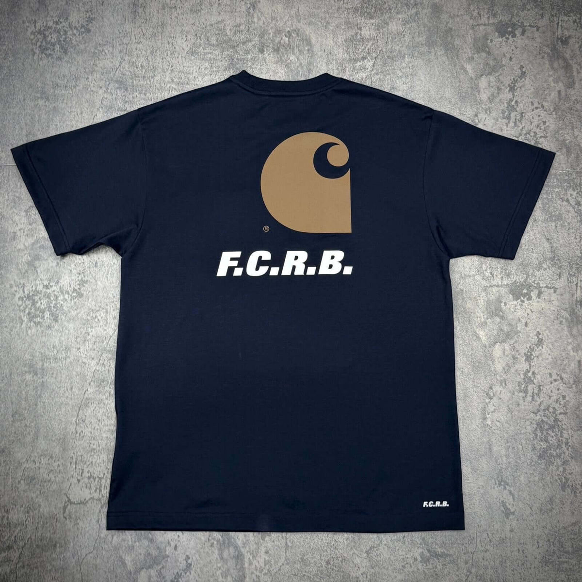 Back view of the Carhartt WIP x F.C.Real Bristol Pocket Tee featuring F.C.R.B. logo and iconic Carhartt design.