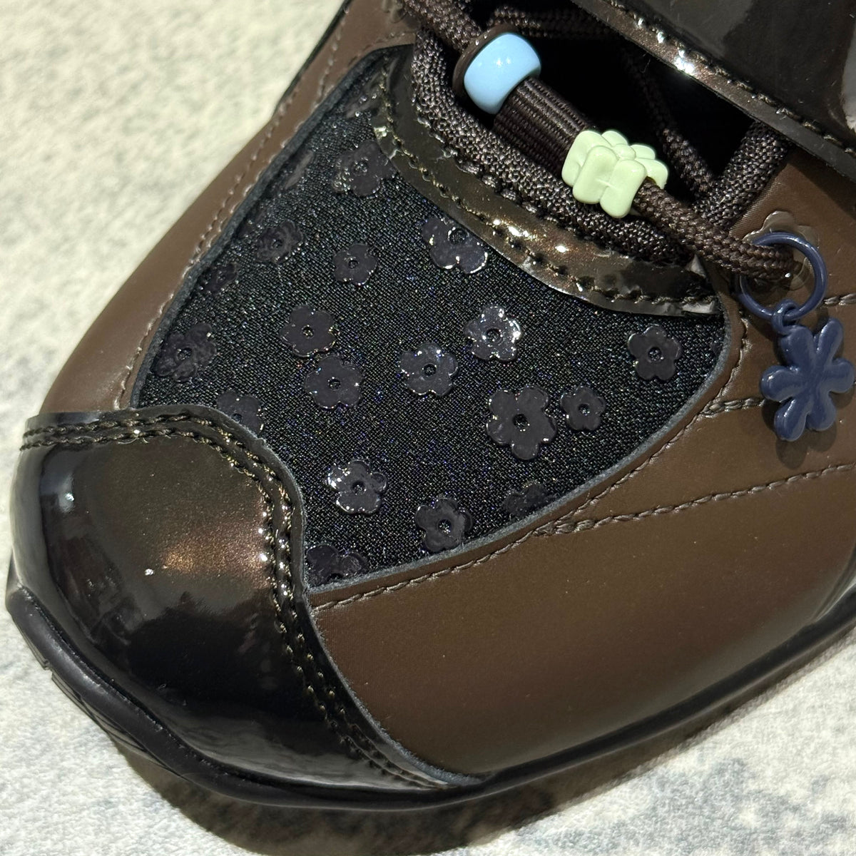 Cecilie Bahnsen x Asics Gel-Kinetic FR - Black Coffee 1203B171-001 brown shoe detail with flower accents