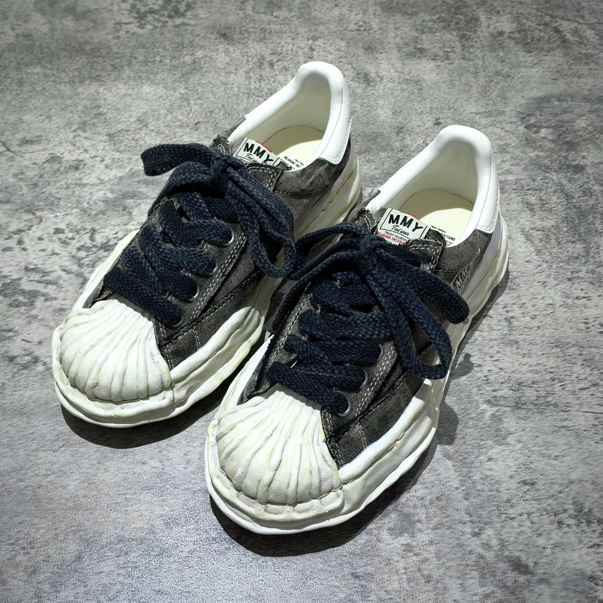 MMY Blakey Bleached Canvas Low - Black A17FW731 featuring a unique bleached design and dark laces on a textured surface.