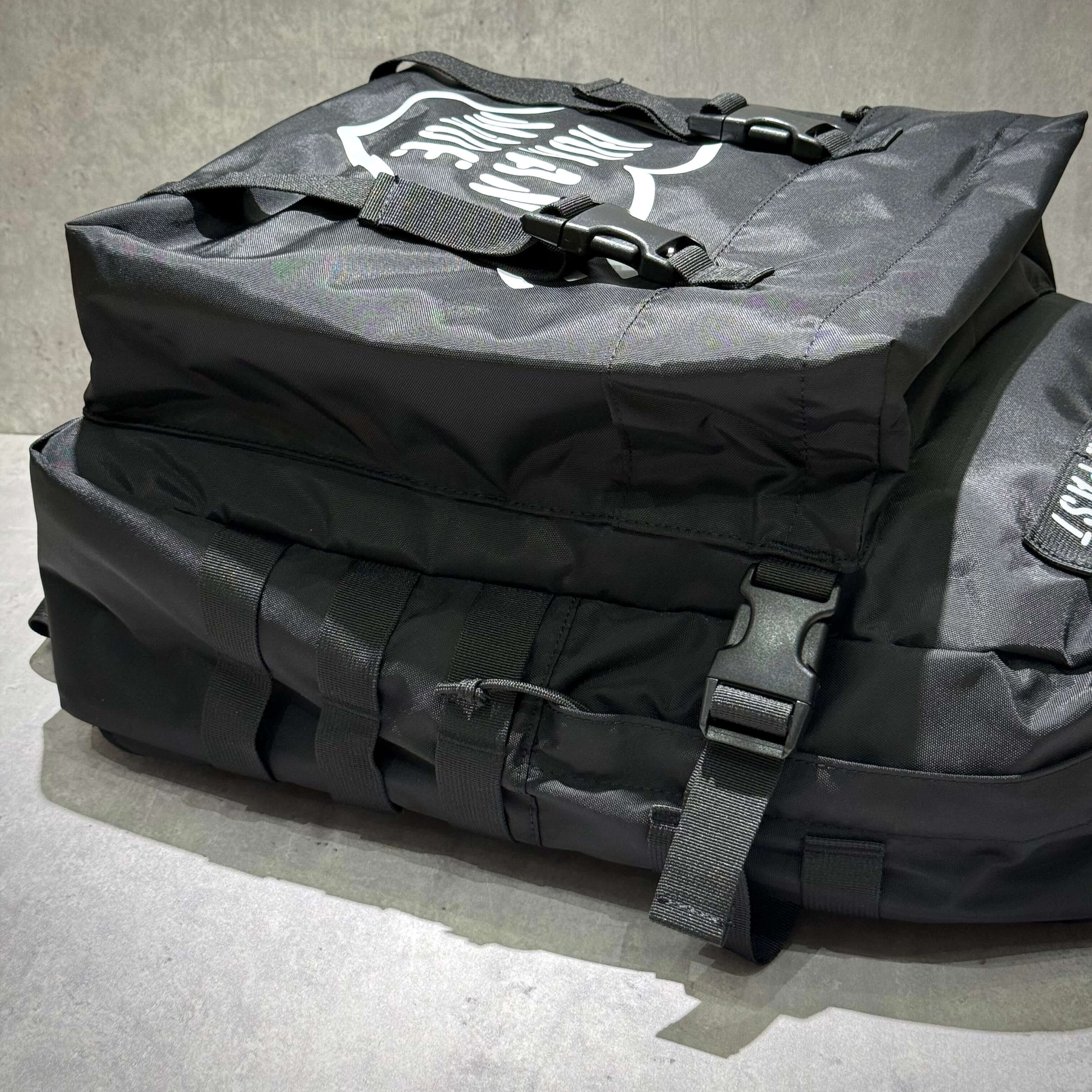 Human Made Military Backpack side view showcasing durable fabric and design features.