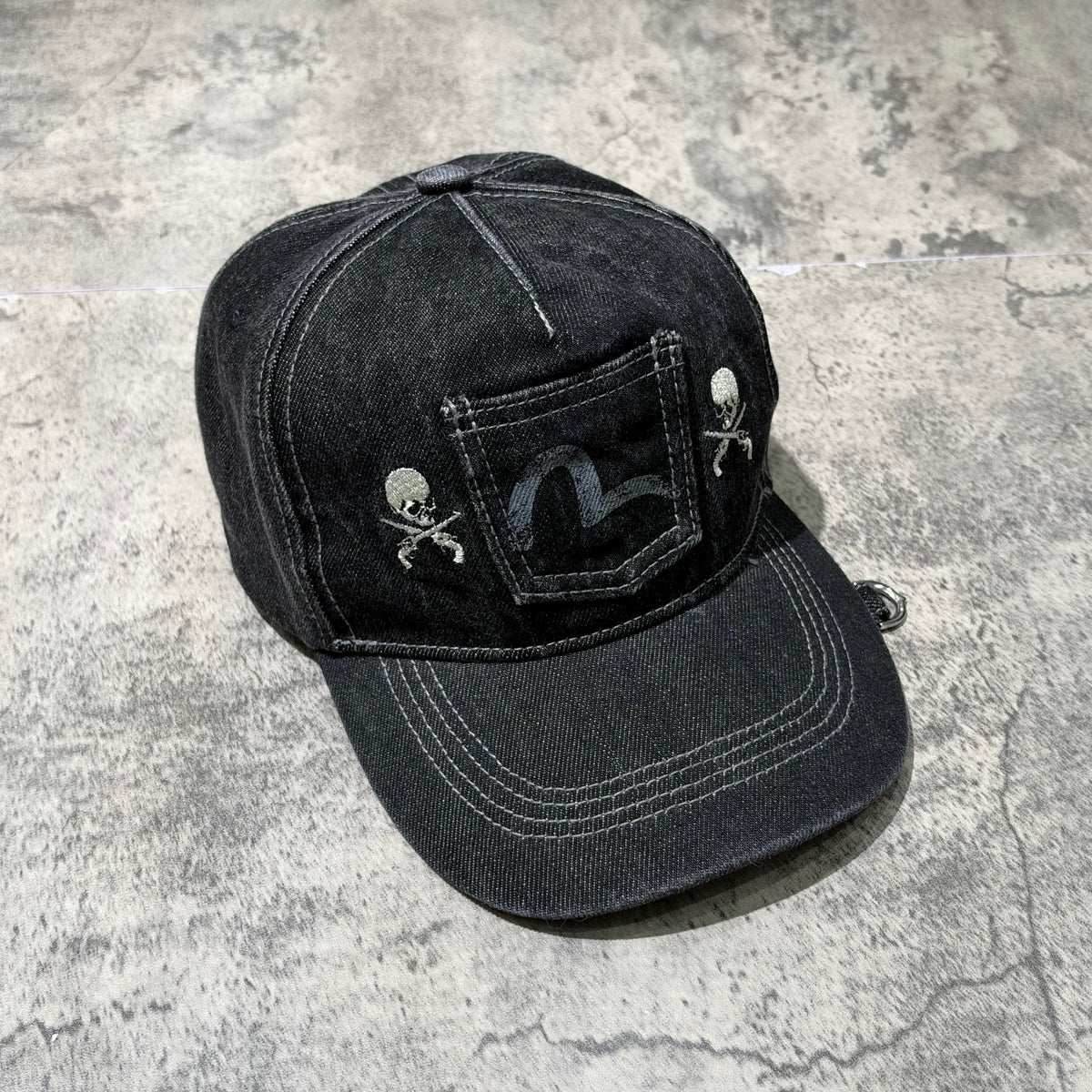 Evisu x Mastermind Japan x Roarguns Cap featuring a unique design with skull motifs and a stylish denim finish.
